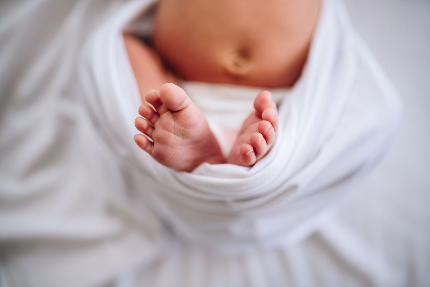 Tiny newborn baby feet against a white background taken during newborn photography session in Melbourne.