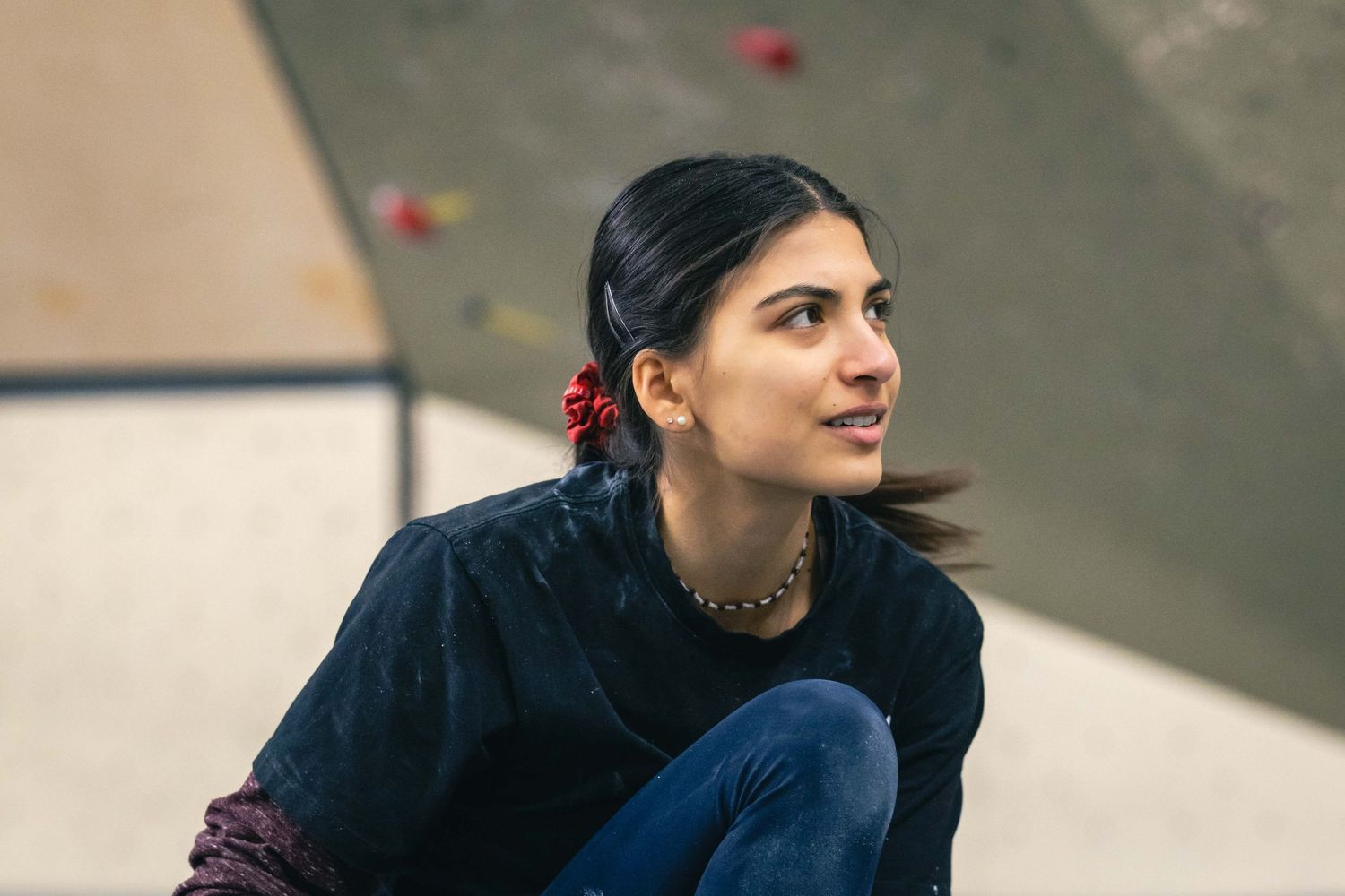 American professional rock climber Natalia Grossman trains on an indoor climbing wall in Paris, France, wearing athletic gear.