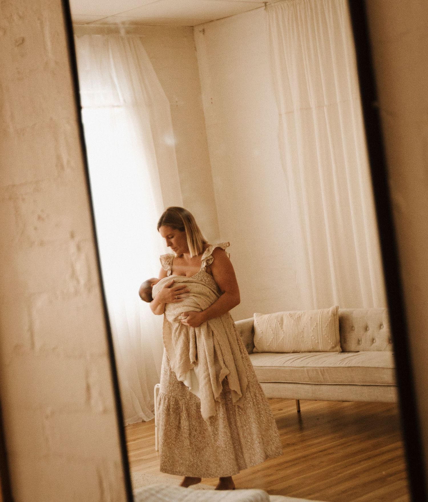 Newborn baby and mother cuddling during lifestyle photoshoot