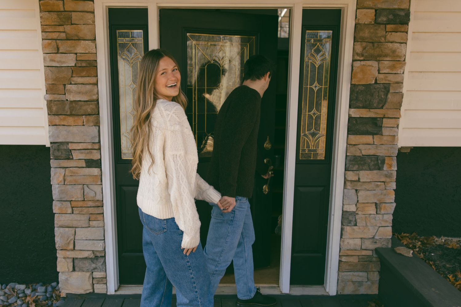 couple new home walking through front door