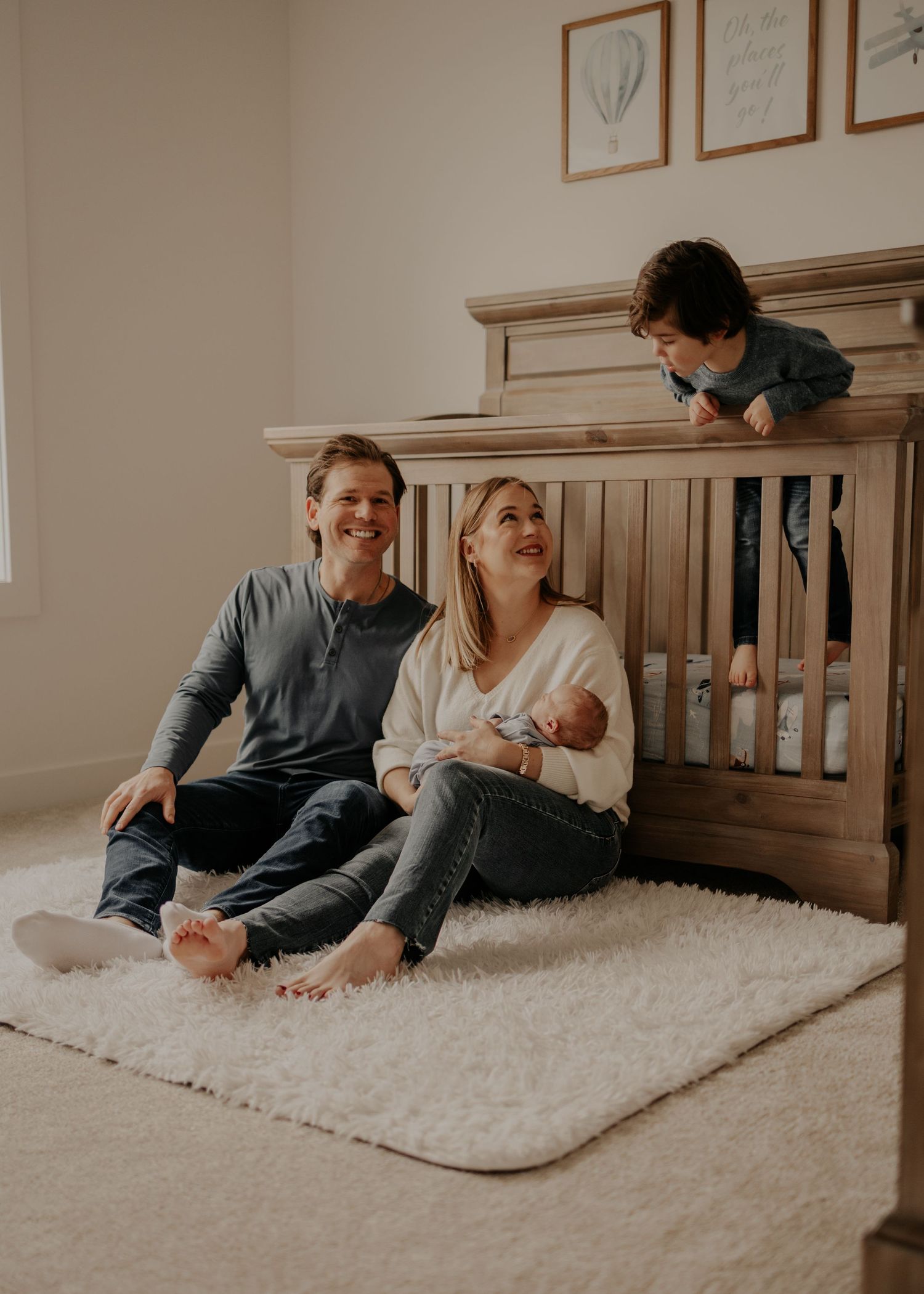 Cozy Minnesota newborn photography session with toddler in nursery