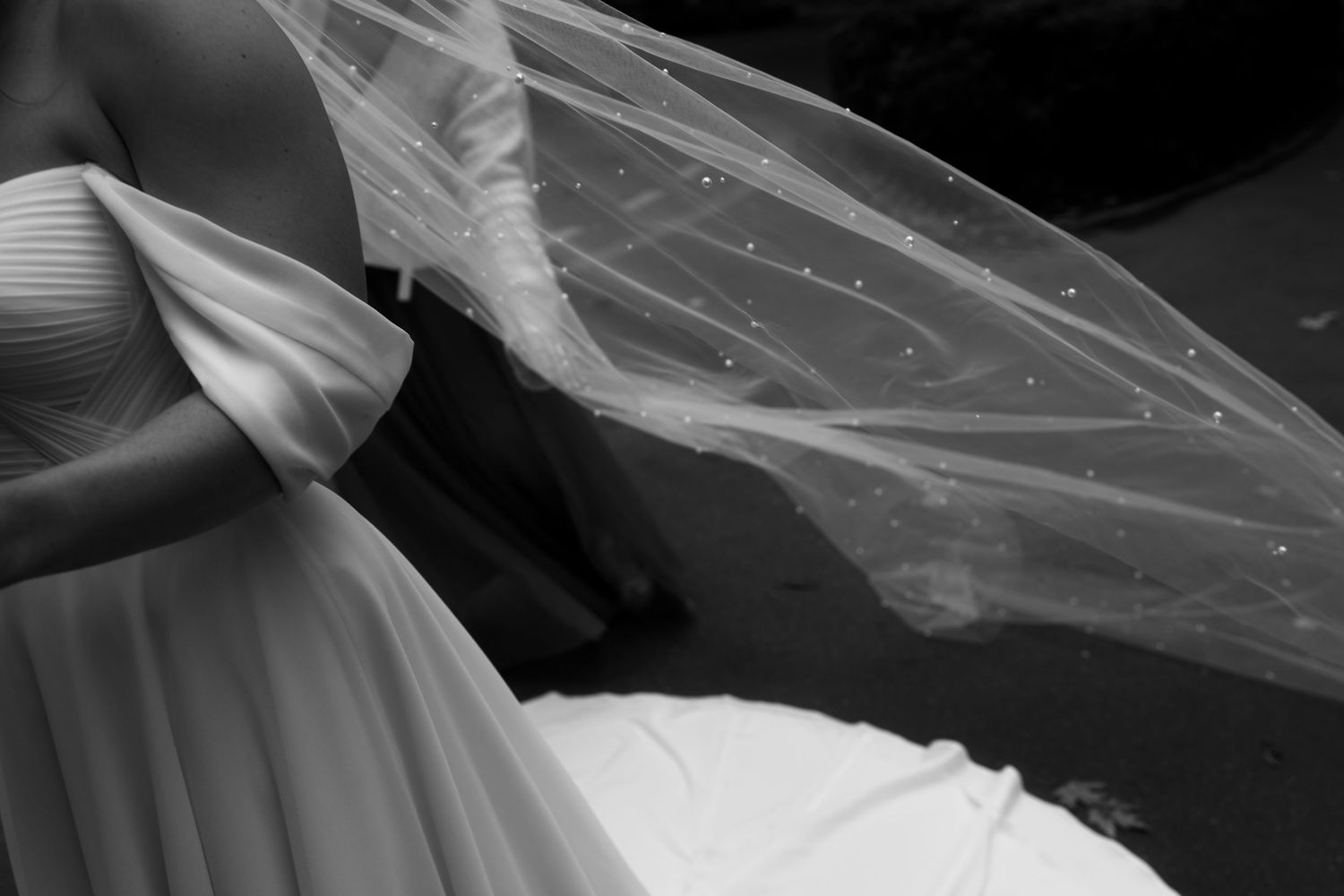 Black and white panoramic sequence showing a couple in formal attire dancing through window reflections.