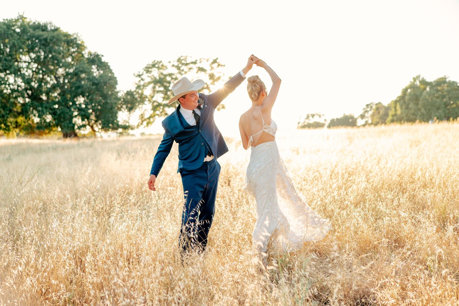 Romantic couple portraits in a golden wheat field at sunset.