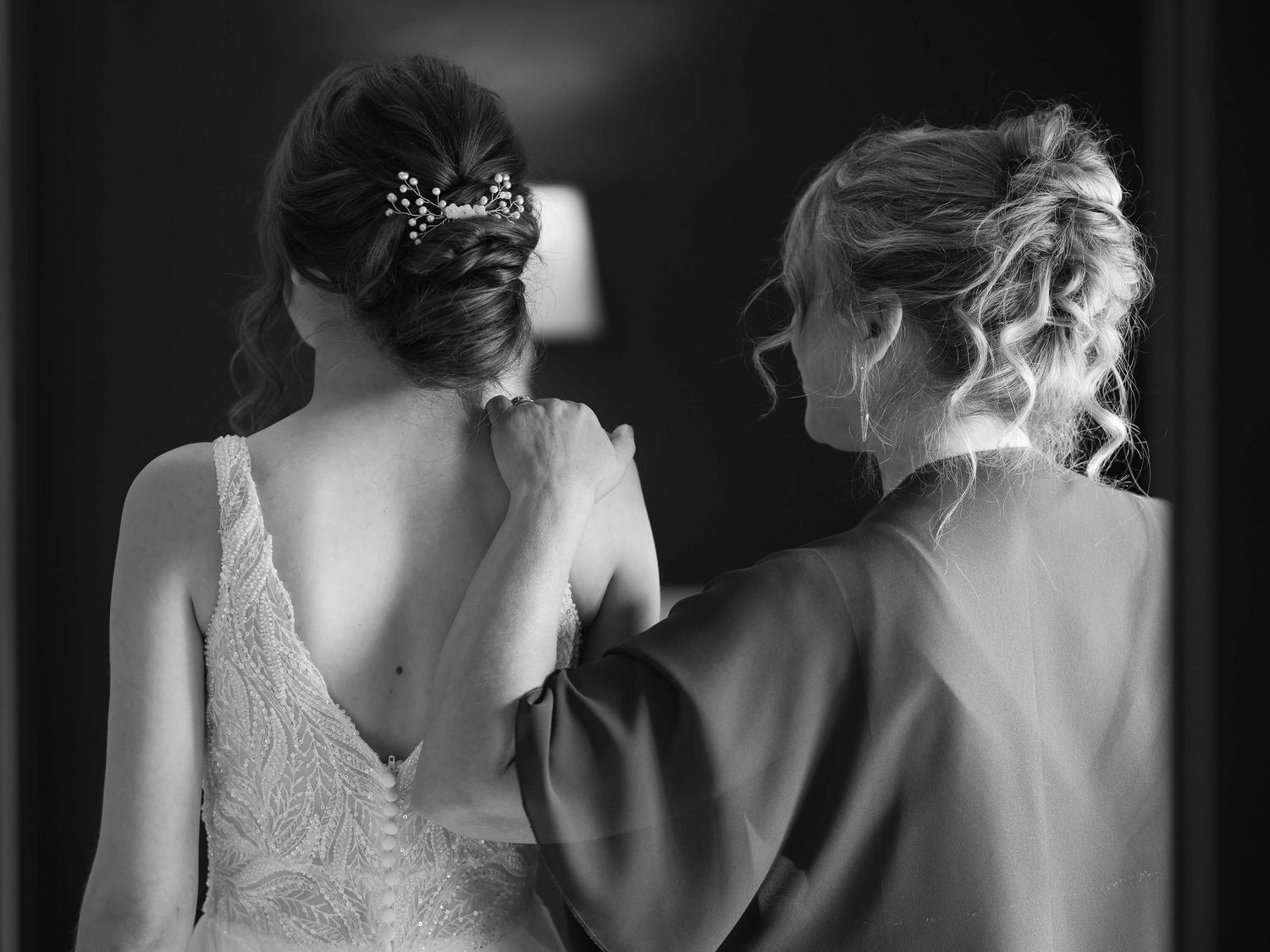 Black and white photos show elegant bridal dresses with lace details and delicate embellishments from different angles.