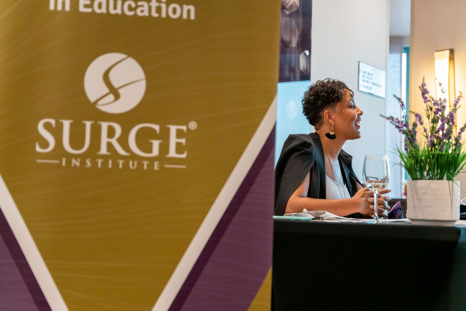 Professional team members collaborating in a modern office space with Surge Institute branding on display.