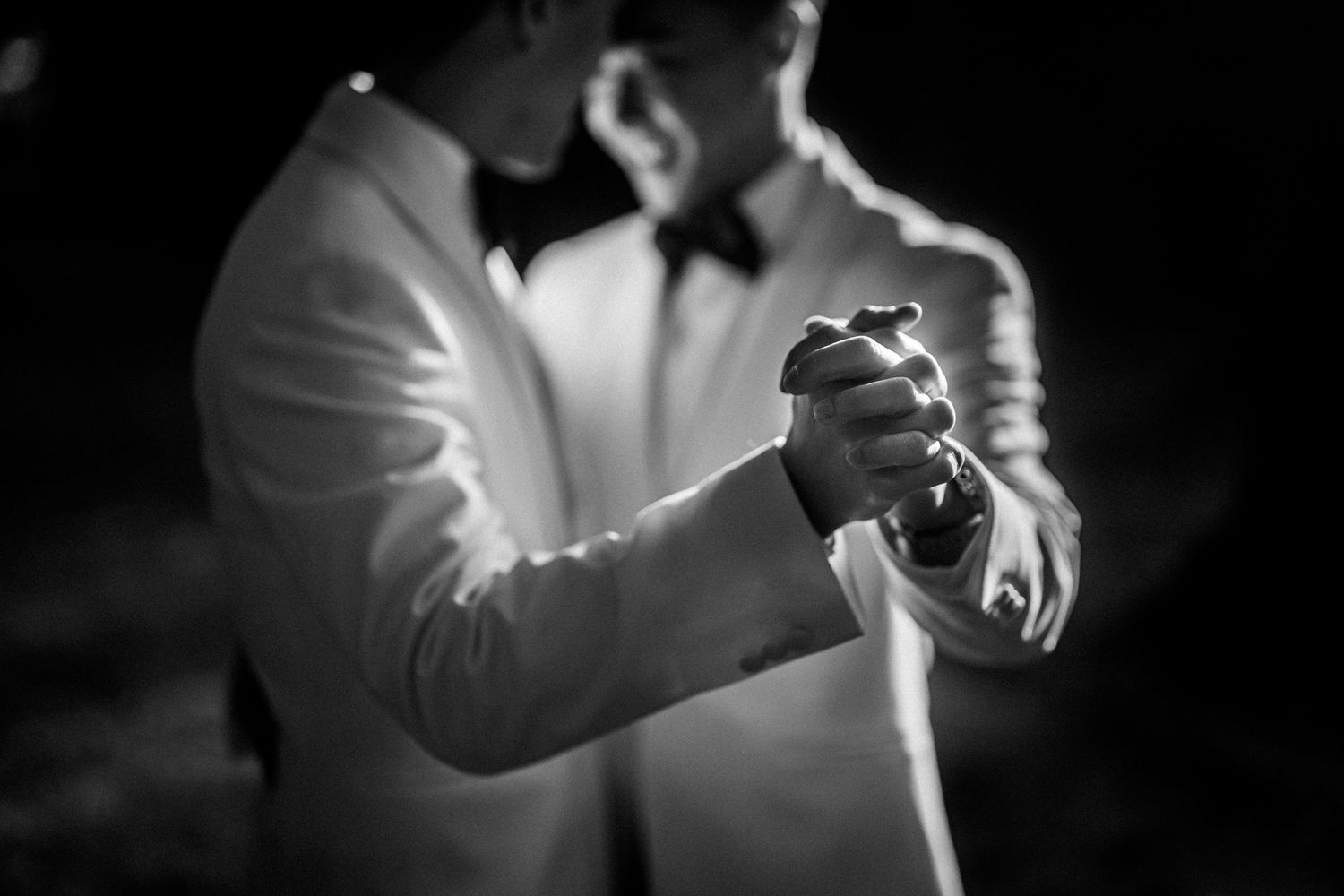 Black and white artistic close-up shots of hands and formal attire.