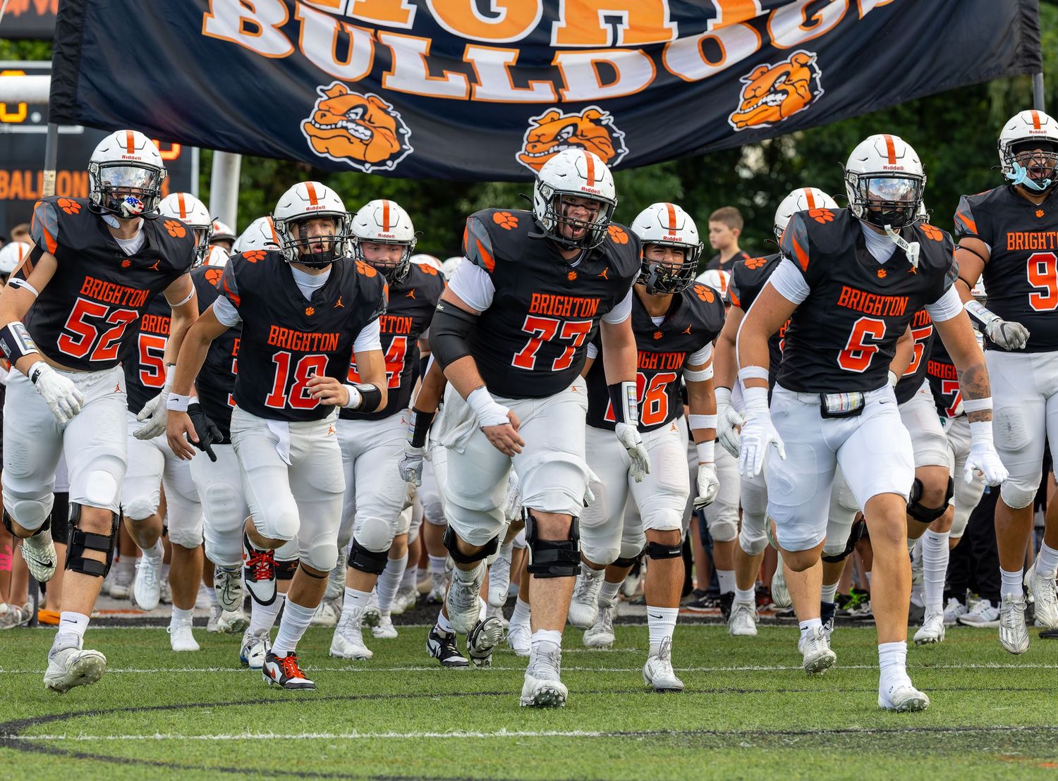 Auburn Tigers football players run onto the field during pregame warmups at Jordan-Hare Stadium.