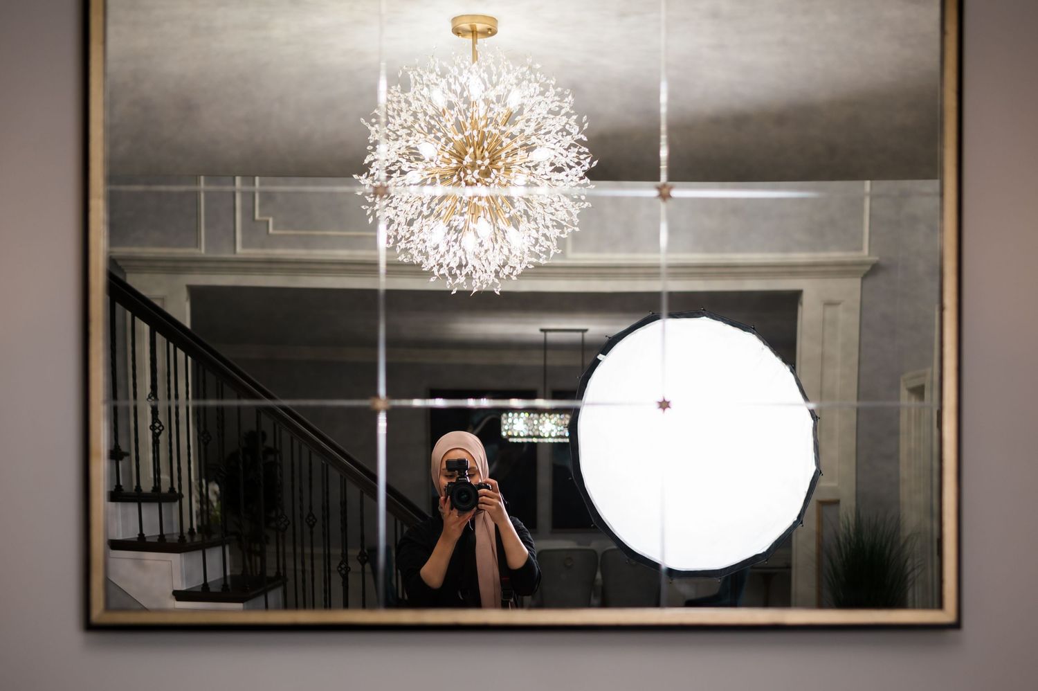 A mirror photo shows a decorative crystal chandelier and a photography studio light setup.