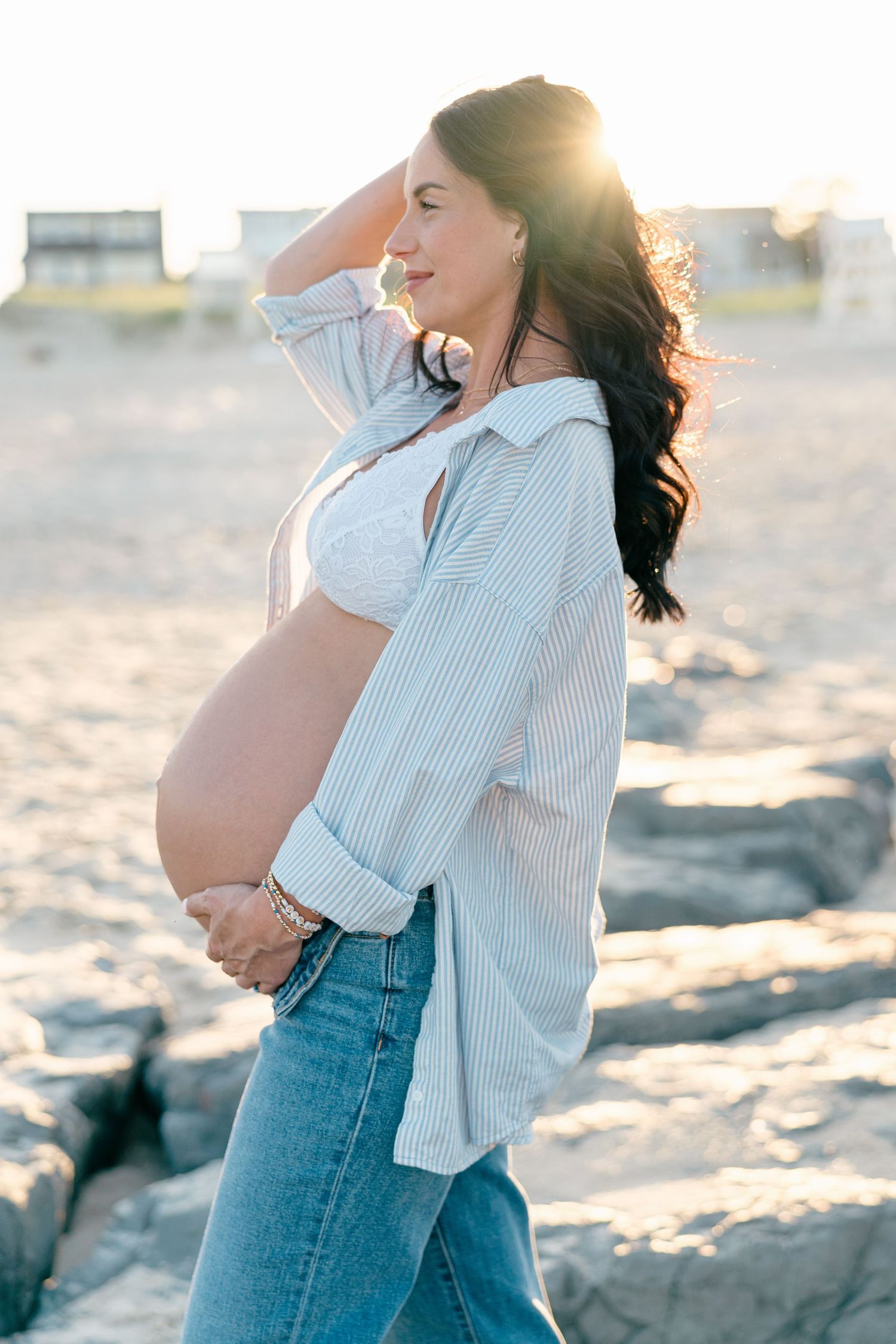 Maternity photo of expectant mother at Spring Lake Beach, Monmouth County NJ wearing white undergarments and oversized button down shirt.