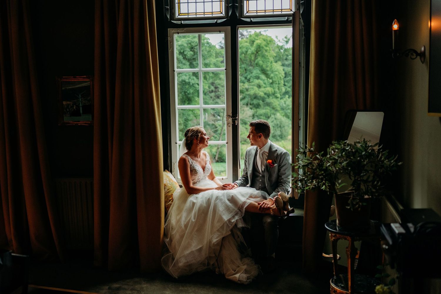 A couple shares a sweet moment together outdoors at a wedding celebration.