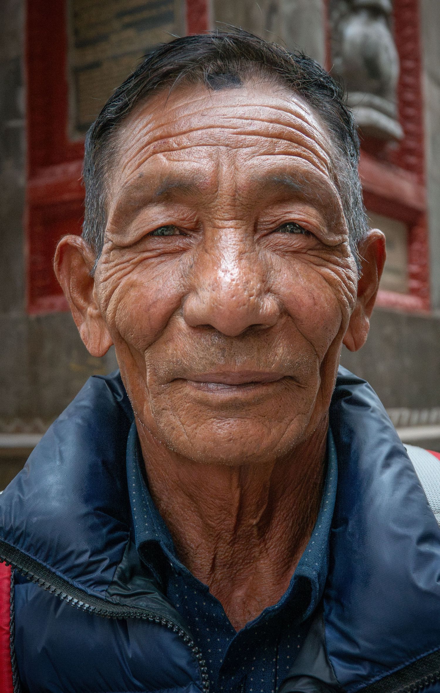 A candid portrait showing warmth and character in traditional setting.
