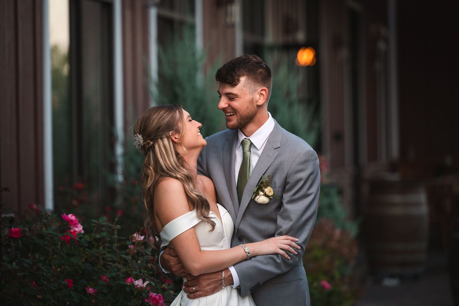 Golden hour wedding portrait with laughing couple in front of brick wall at The Barn at Villa Venezia Middletown, NY.