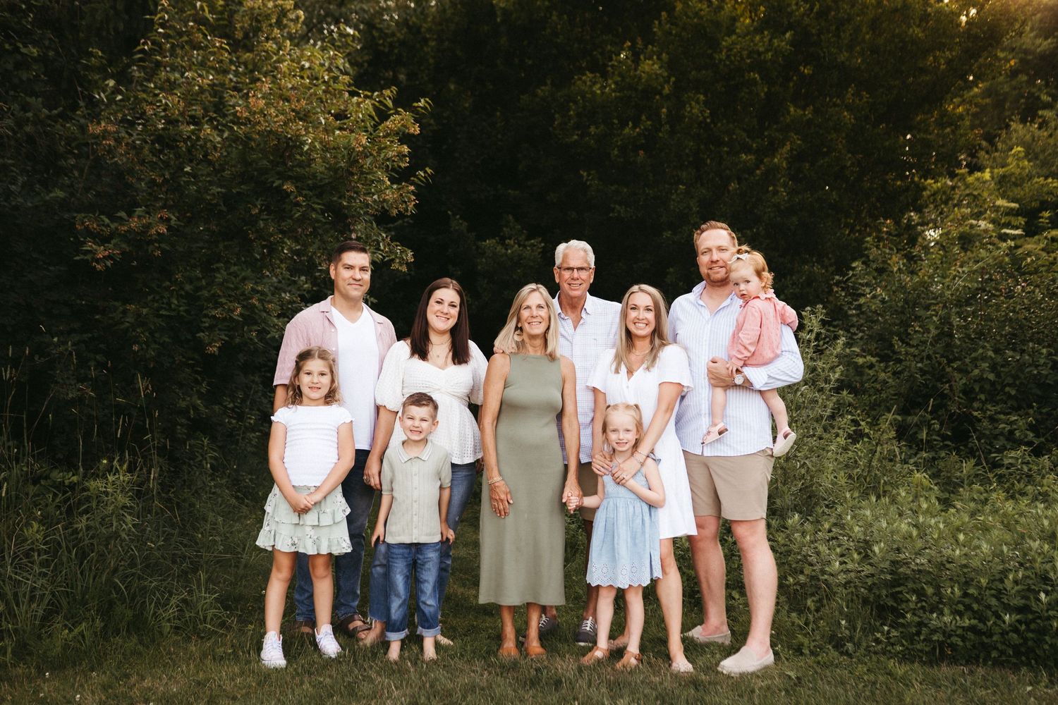 A series of outdoor family portrait photographs taken in a natural wooded setting during golden hour.