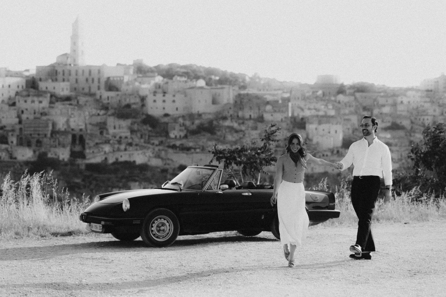 A series of six vintage black and white photos showing automobiles parked along Mediterranean hillside roads.