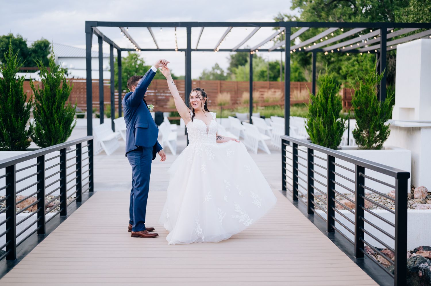 Panoramic sequence of bride and groom walking along a modern railing walkway during an outdoor wedding ceremony.
