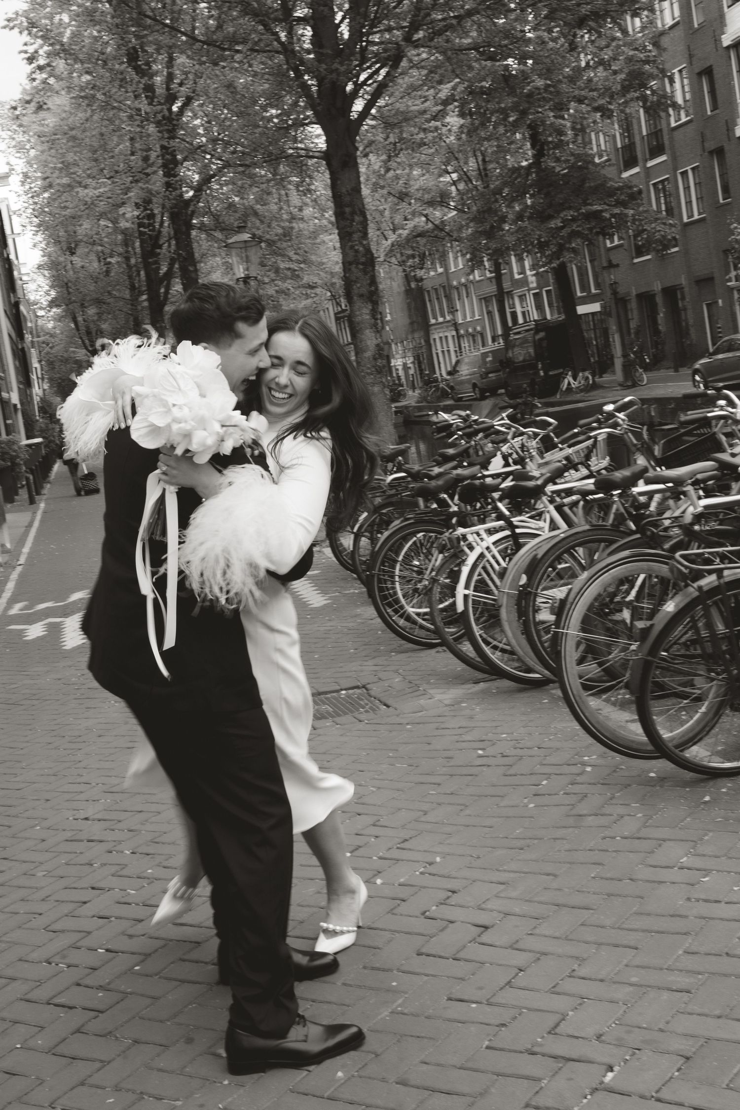 A romantic boat ride through Amsterdam's scenic canals with historic buildings and waterfront architecture in the background.