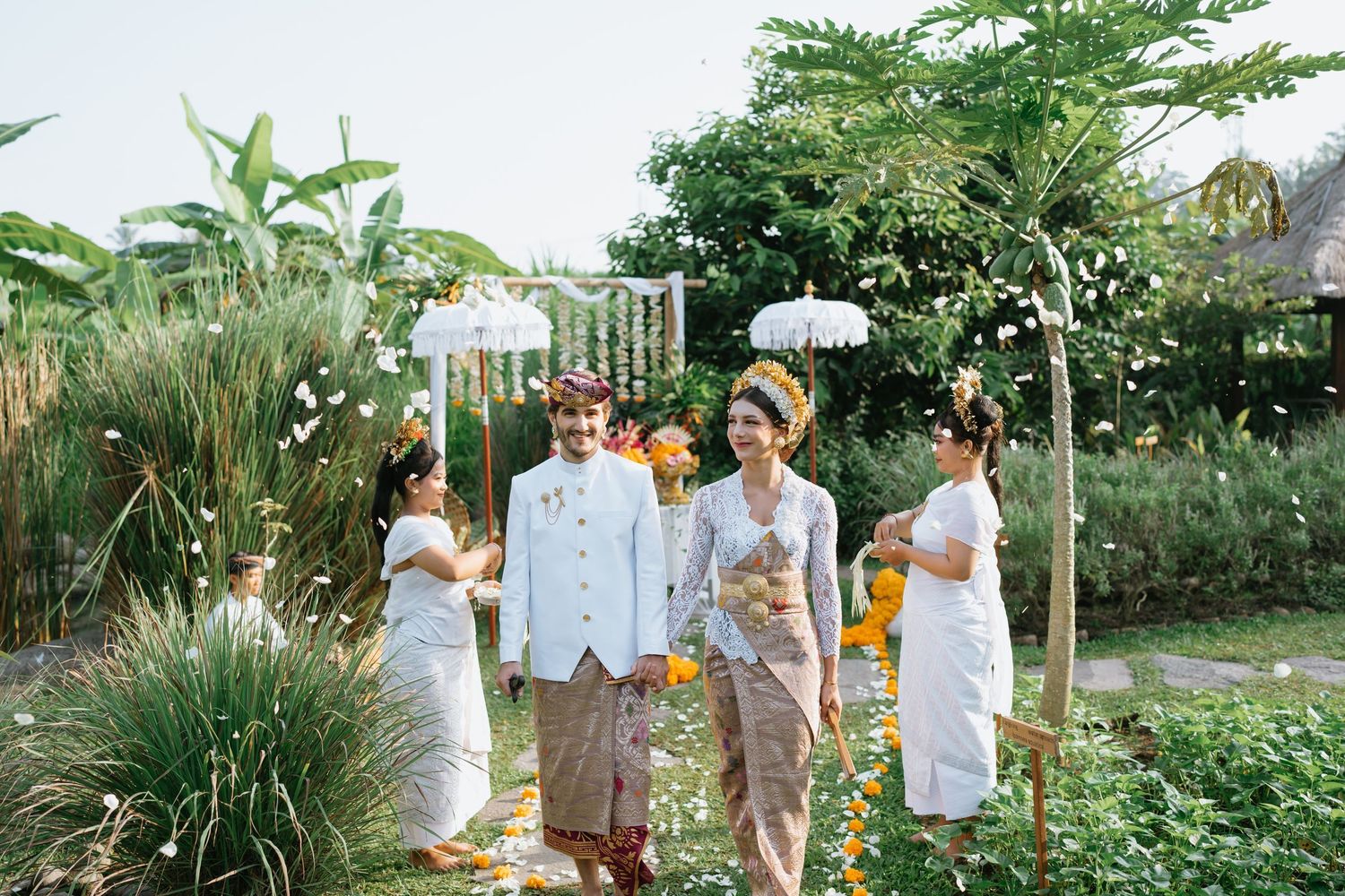 Romantic outdoor wedding photoshoot among bamboo trees and natural greenery.