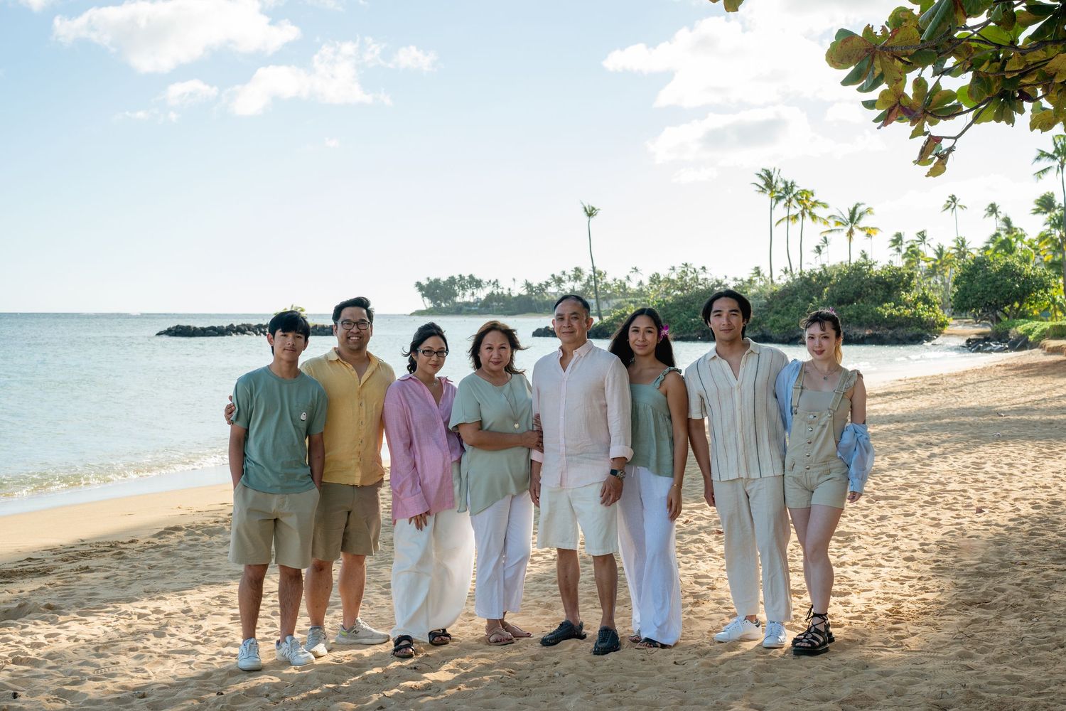 family on waikiki beach posing for a photo