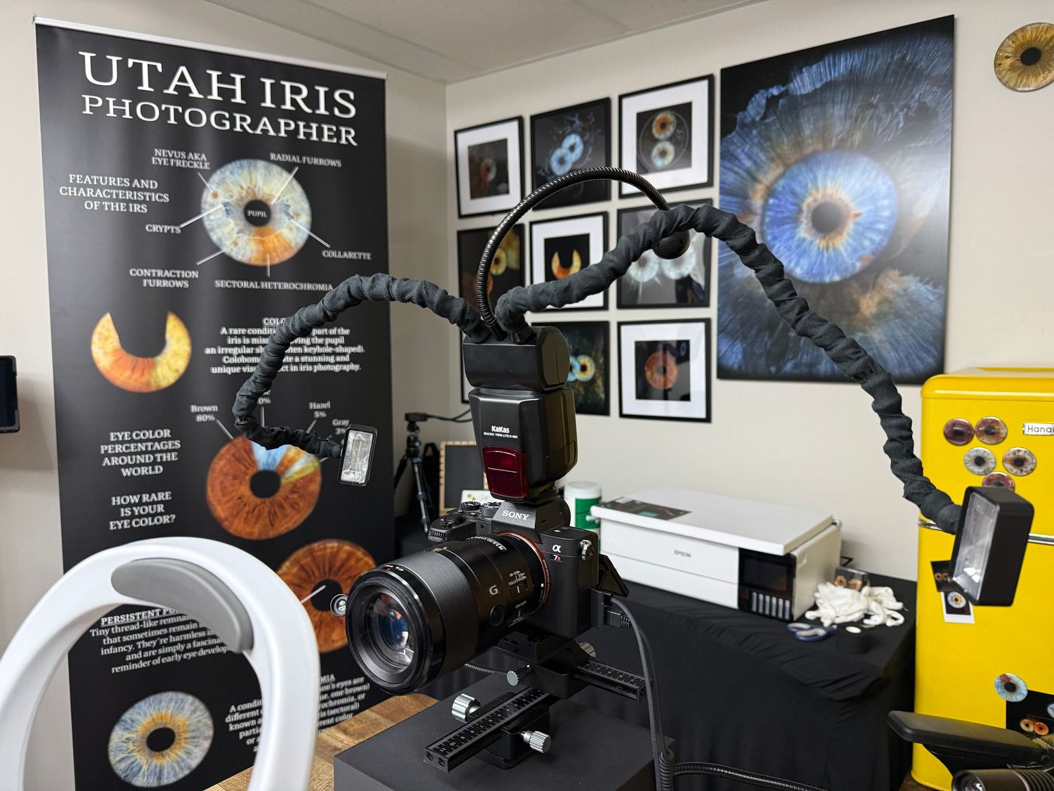 Professional camera setup mounted on a stand with headphones and audio recording equipment in a studio environment.