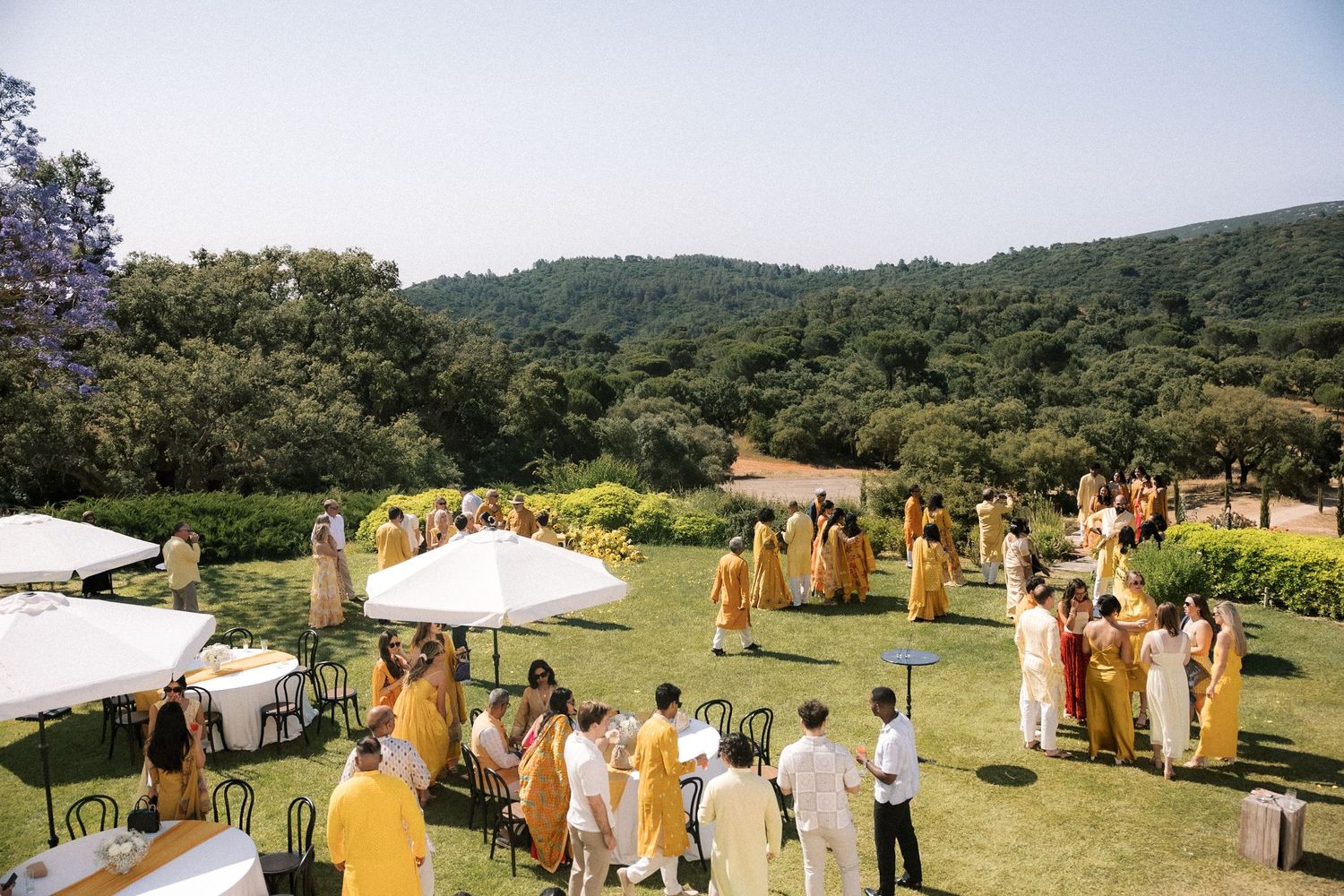 guests dressed in yellow during Haldi ceremony in Portugal