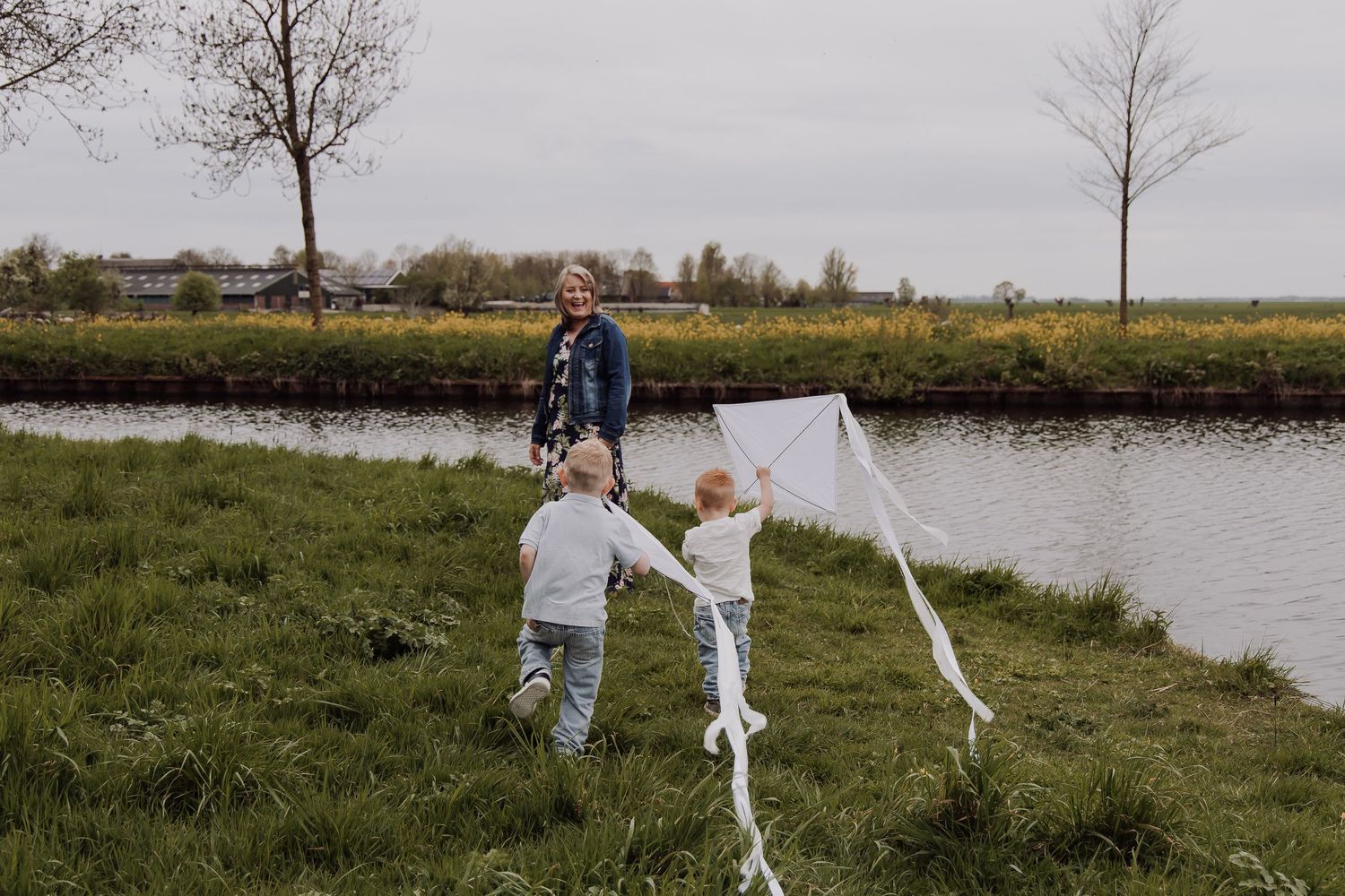 Expat family photoshoot in the Netherlands with South African grandmother playing with children outdoors in Woerden, Utrecht.