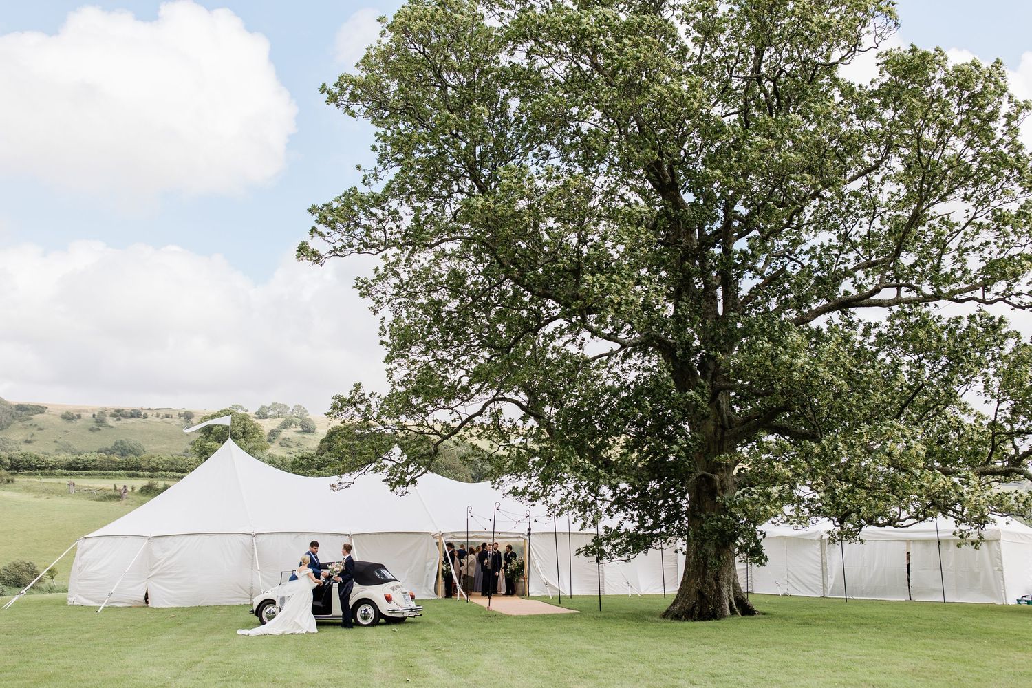 Marque wedding reception set in the rolling Dorset country side, photographed by Maddie Waters Dorset wedding photographer