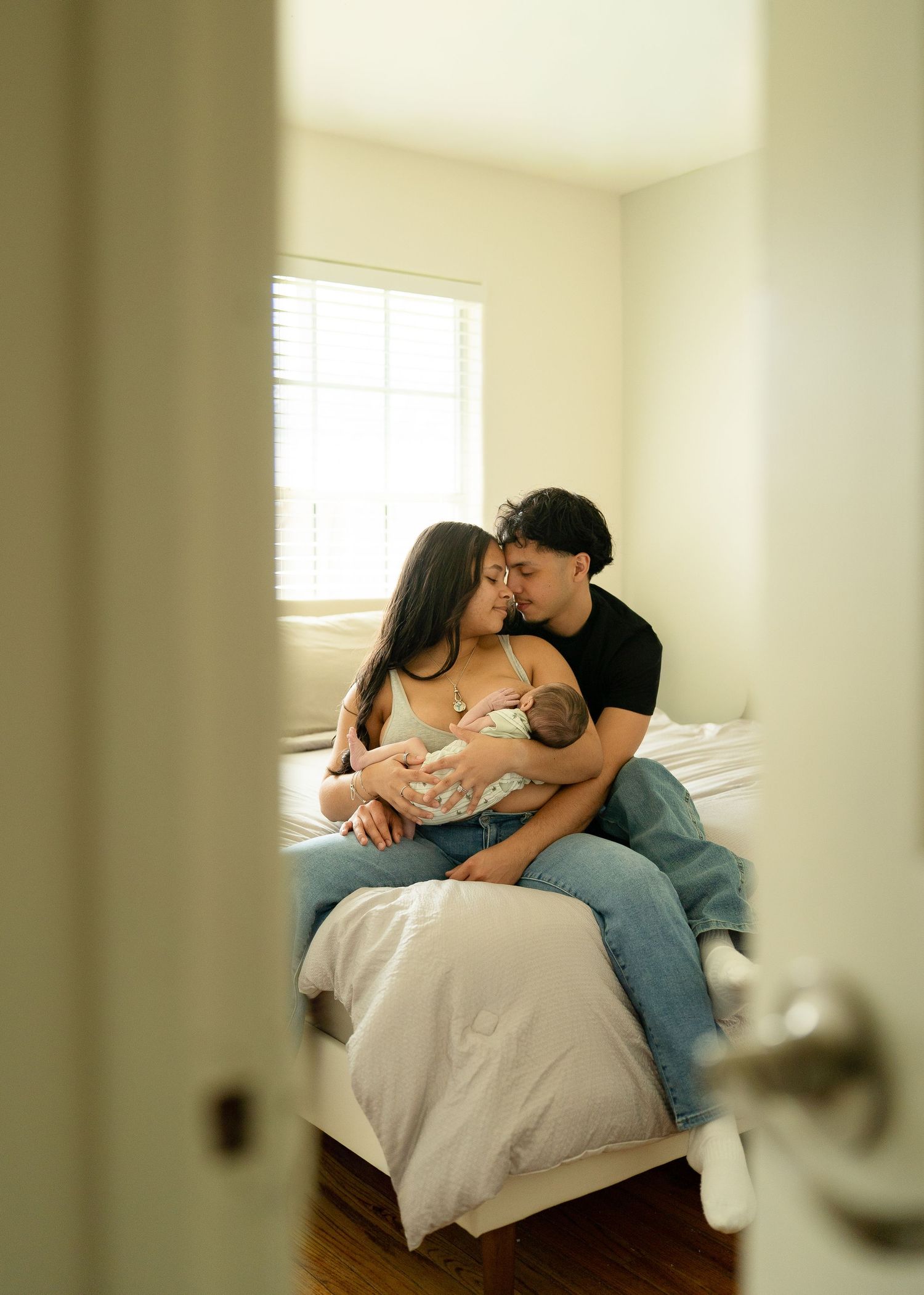 First-time parents cuddling newborn during relaxed Houston lifestyle session