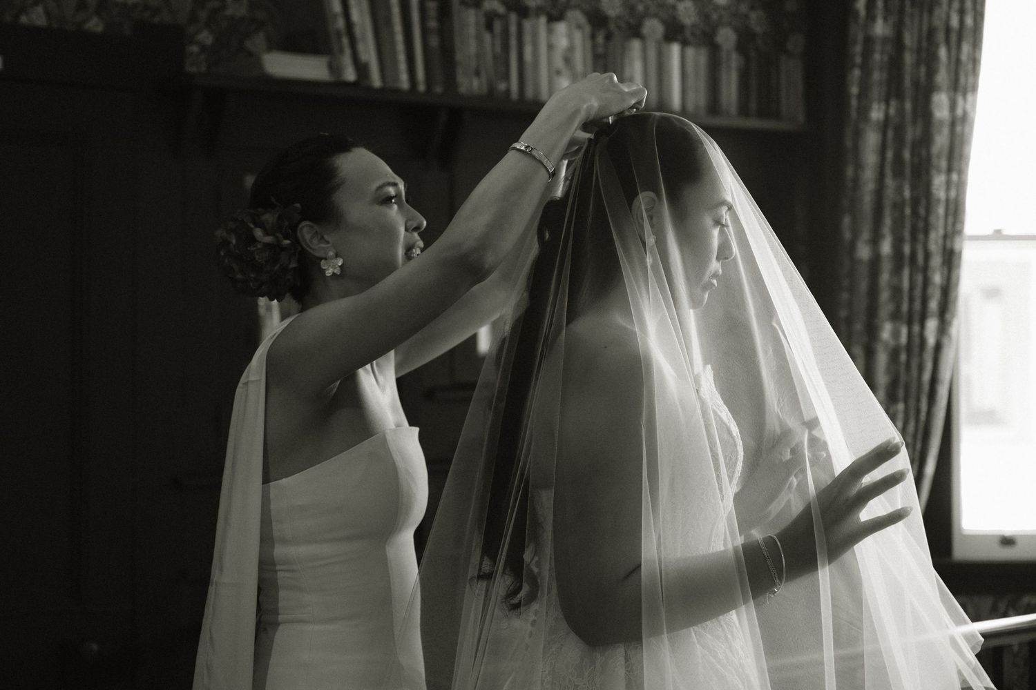 Delicate white veil flows in the breeze during an outdoor wedding ceremony.