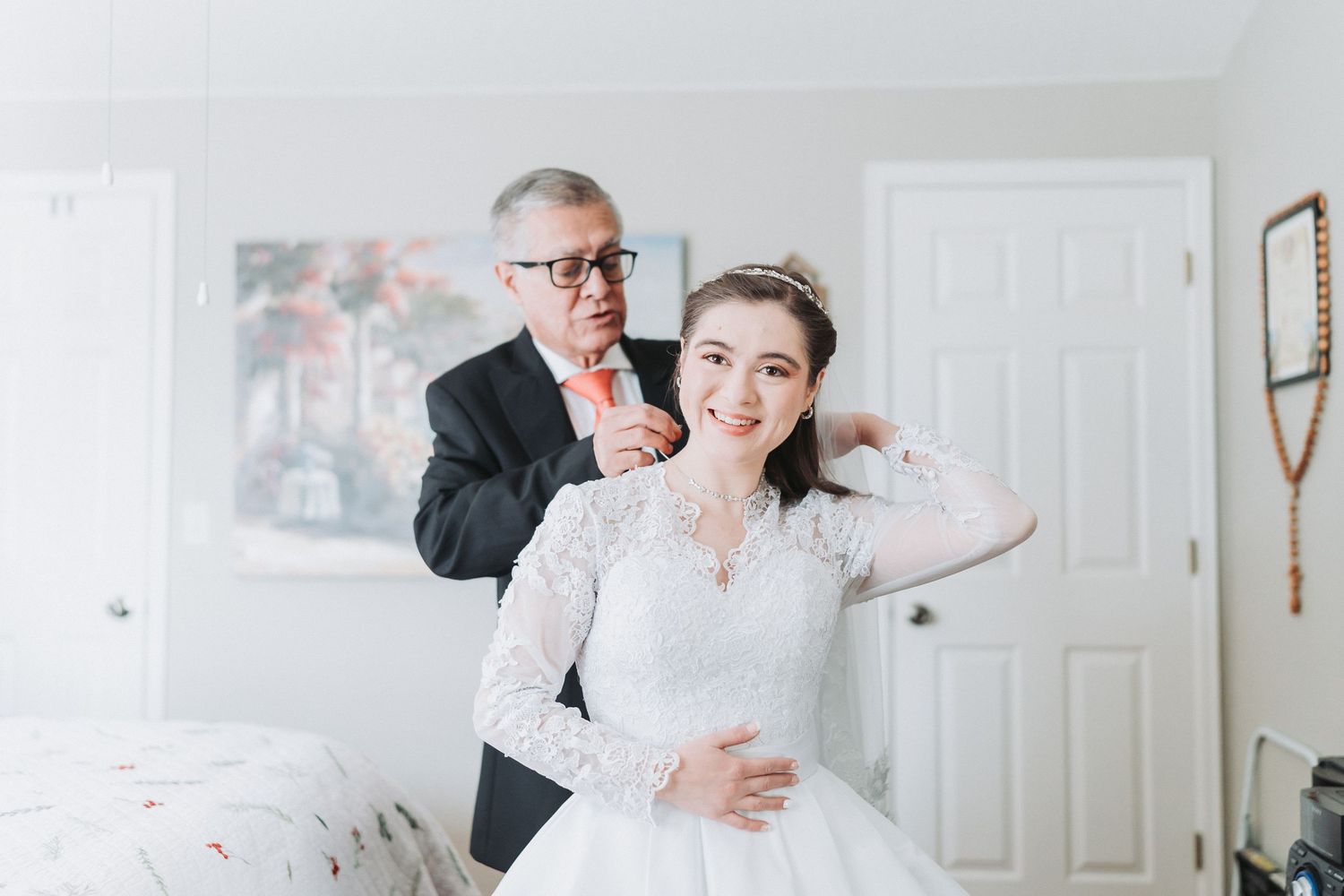 Professional photographer captures candid moments during a wedding photoshoot in a bright indoor setting.