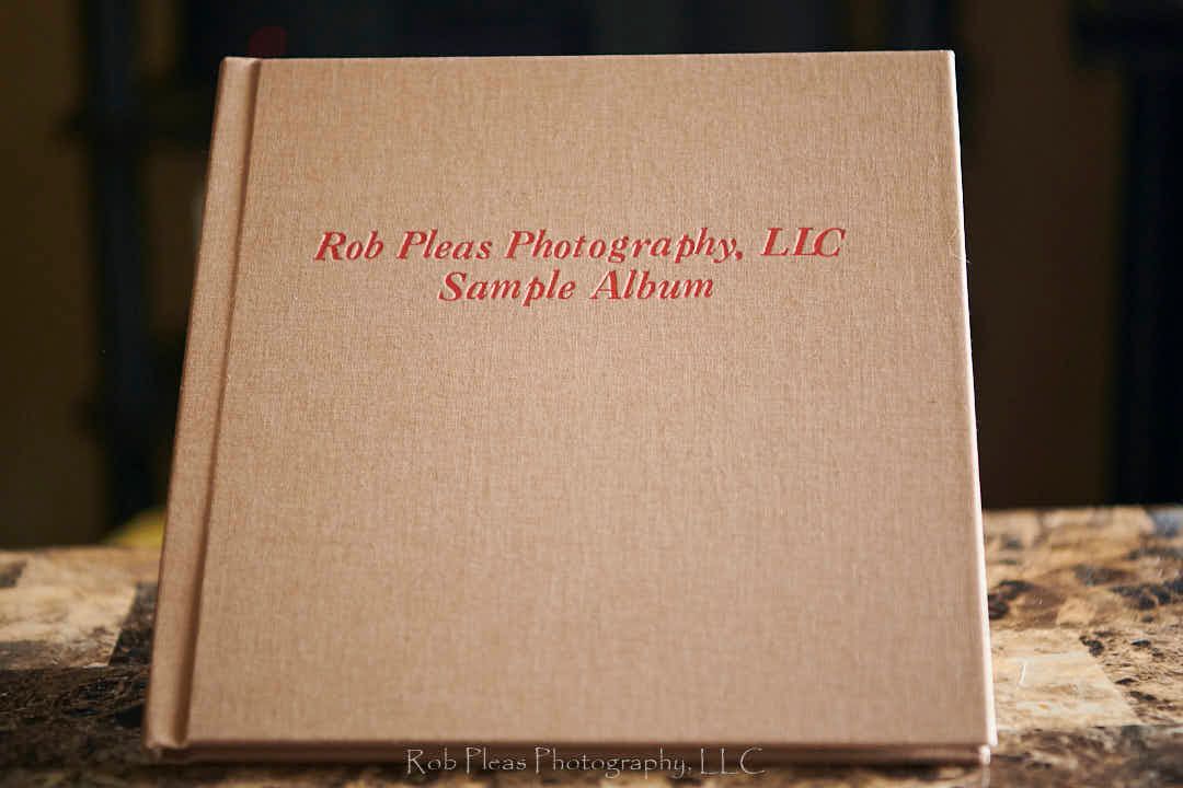 High school senior Memory album with linen cover. Shown on bookstand on coffee table.