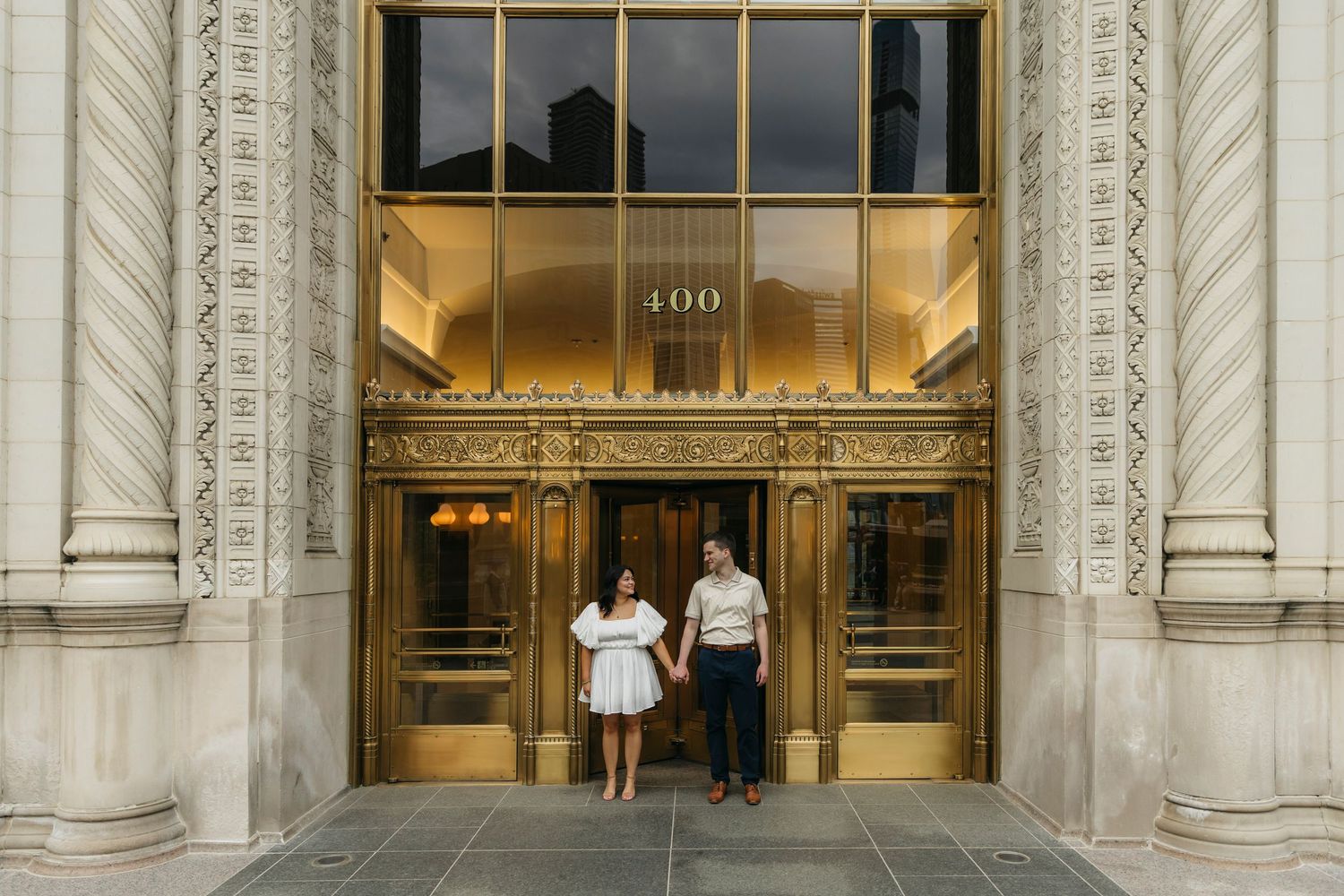 Couple wearing neutral elegant outfits during engagement session in Chicago