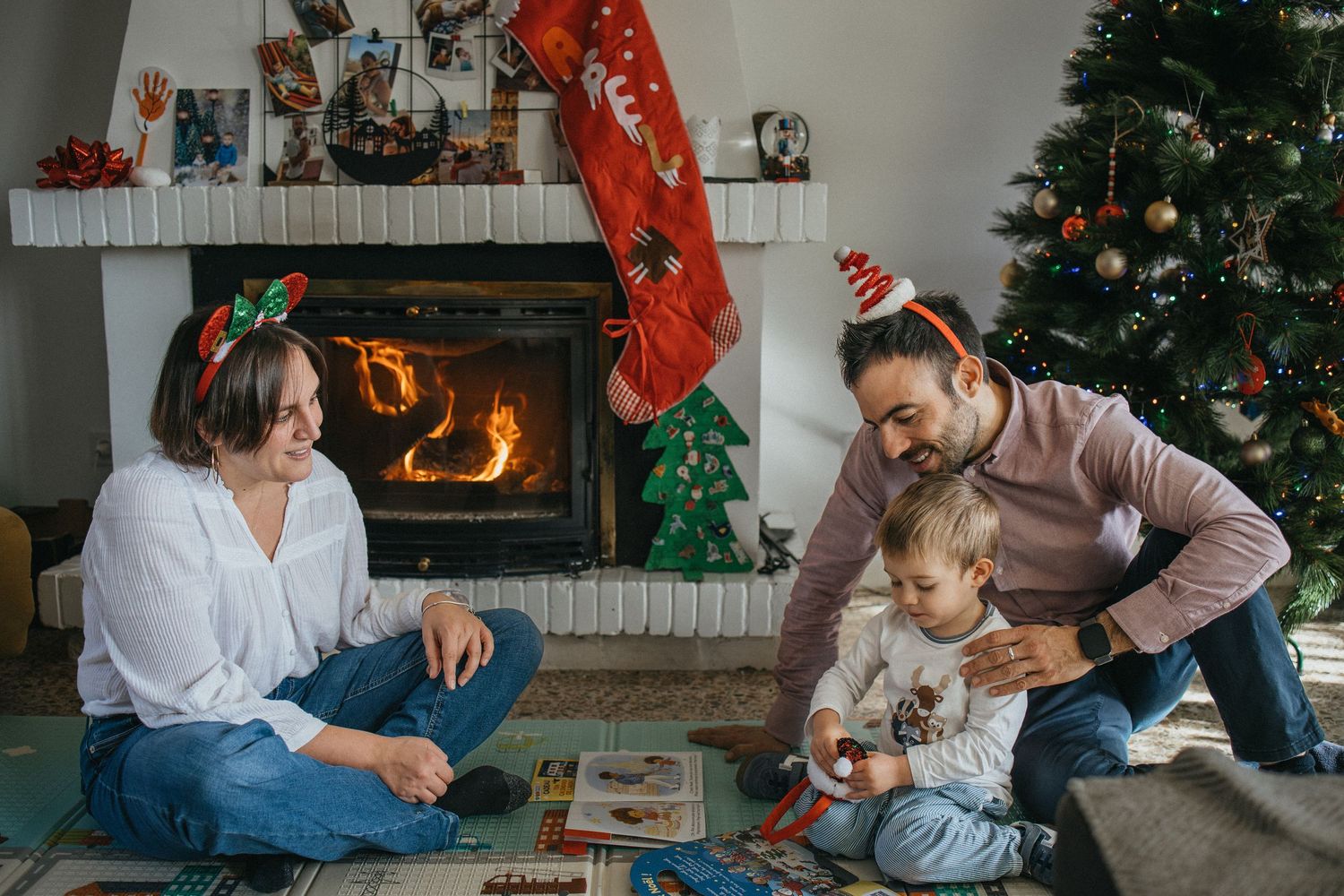 Family relaxes together on a colorful patterned couch in a bright living room.