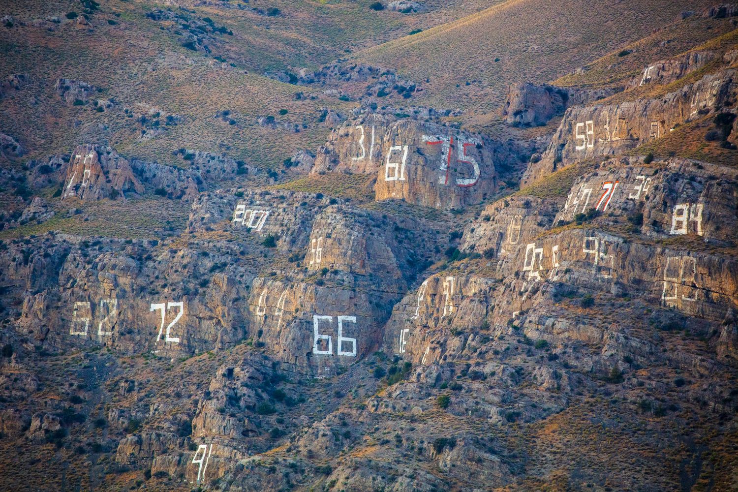 white people ruin everything. a hillside polluted by graffiti in arco, idaho. they call it 'number hill'.