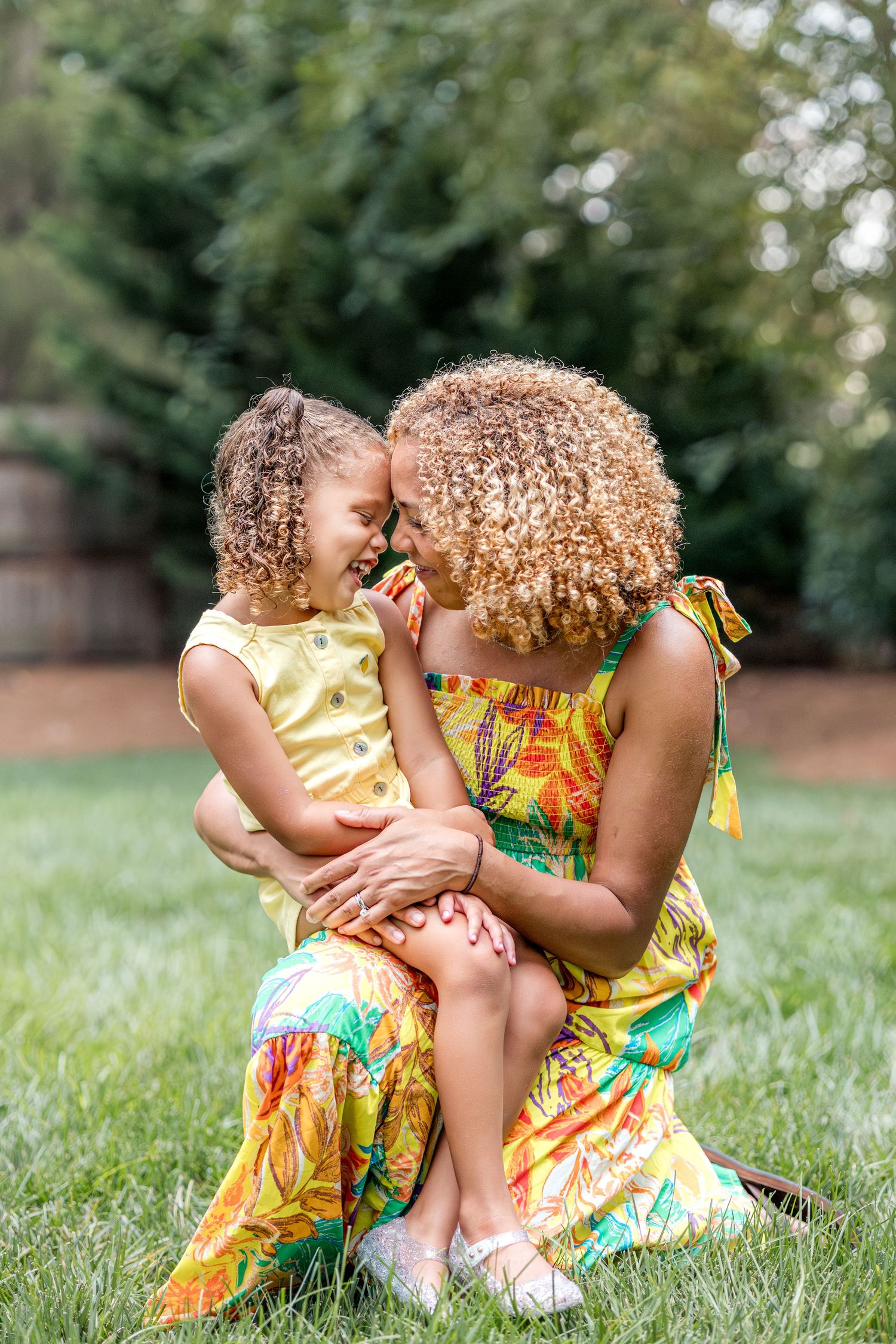 african american mother and daughter in backyard photo session in their home in Cary, North Carolina. In-home sessions by Sam T. Photography