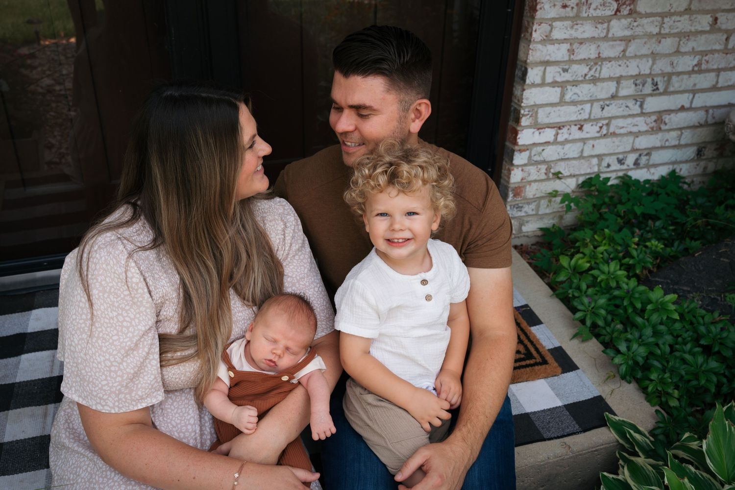 Family snuggling during lifestyle newborn photo shoot in Platine