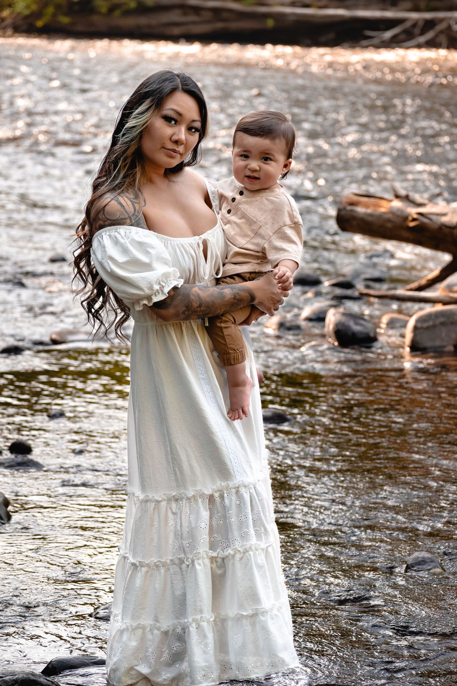 Mother holding one-year-old son during golden hour photos at Flaming Geyser State Park in Washington