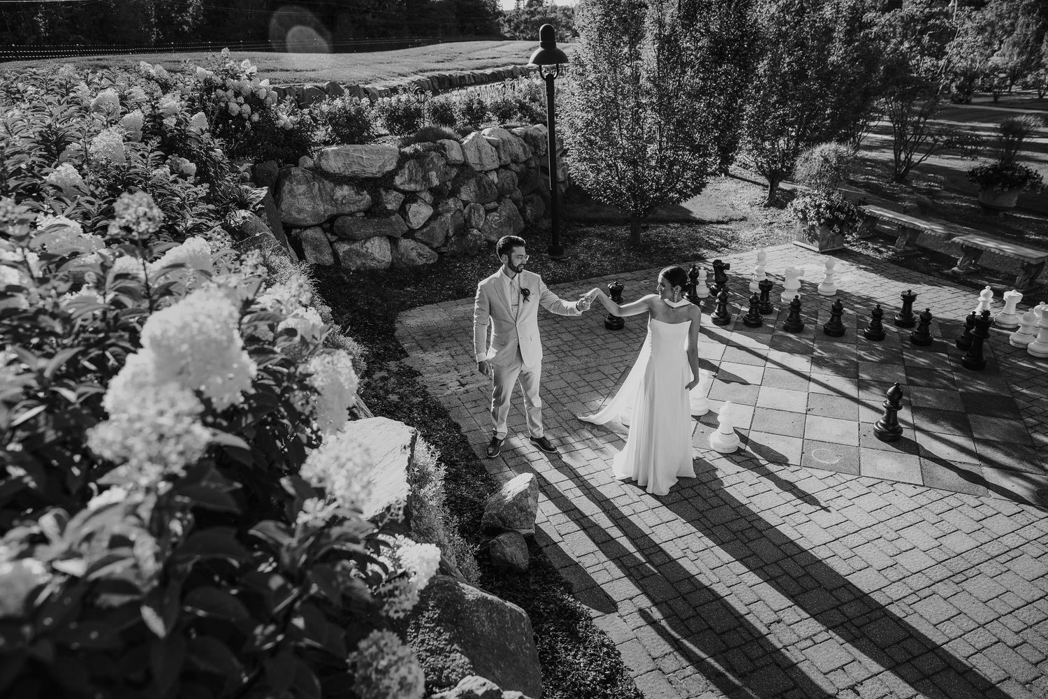 Black and white wedding ceremony setting with elegant floral arrangements.