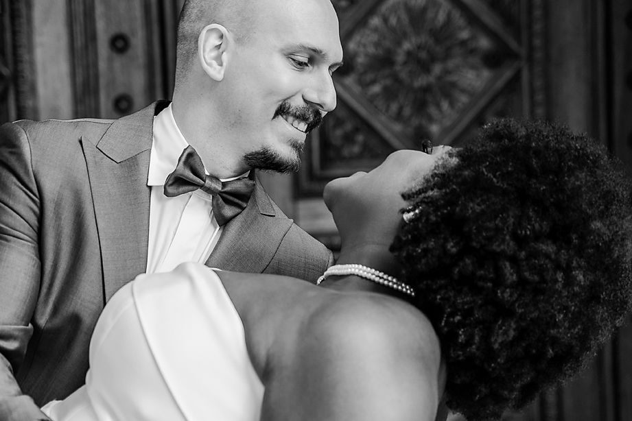 Wedding party sharing joyful moments and laughter together at an outdoor celebration.