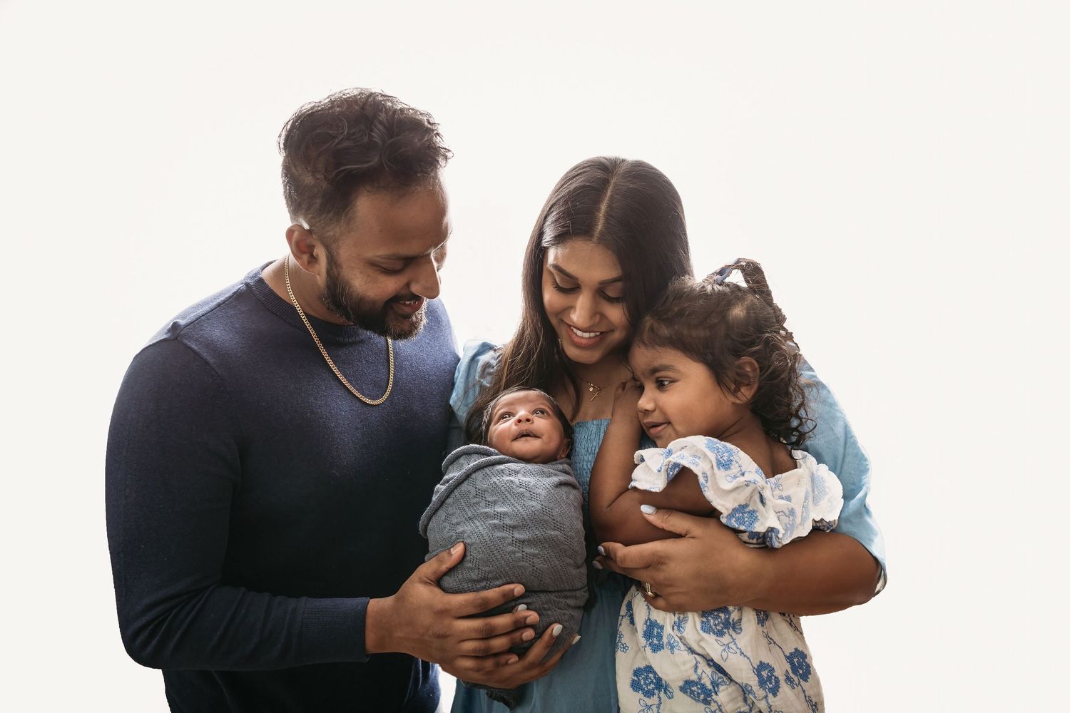 Family sharing joyful moment together against white background.