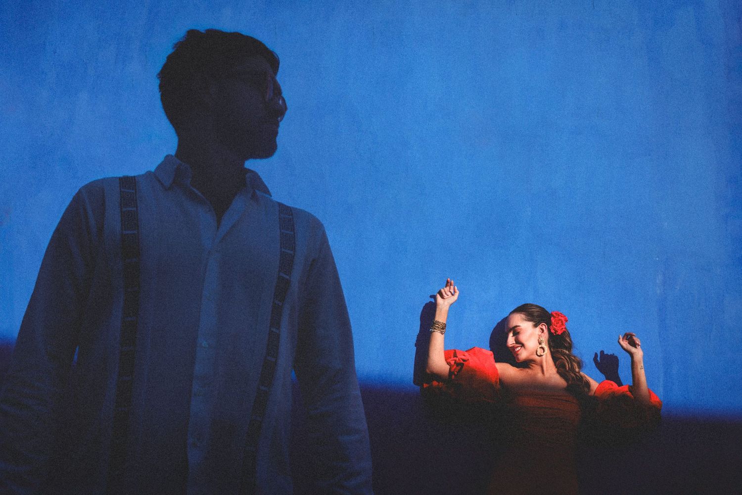 A dramatic dance performance on stage with blue lighting and silhouettes creating an atmospheric theatrical scene.