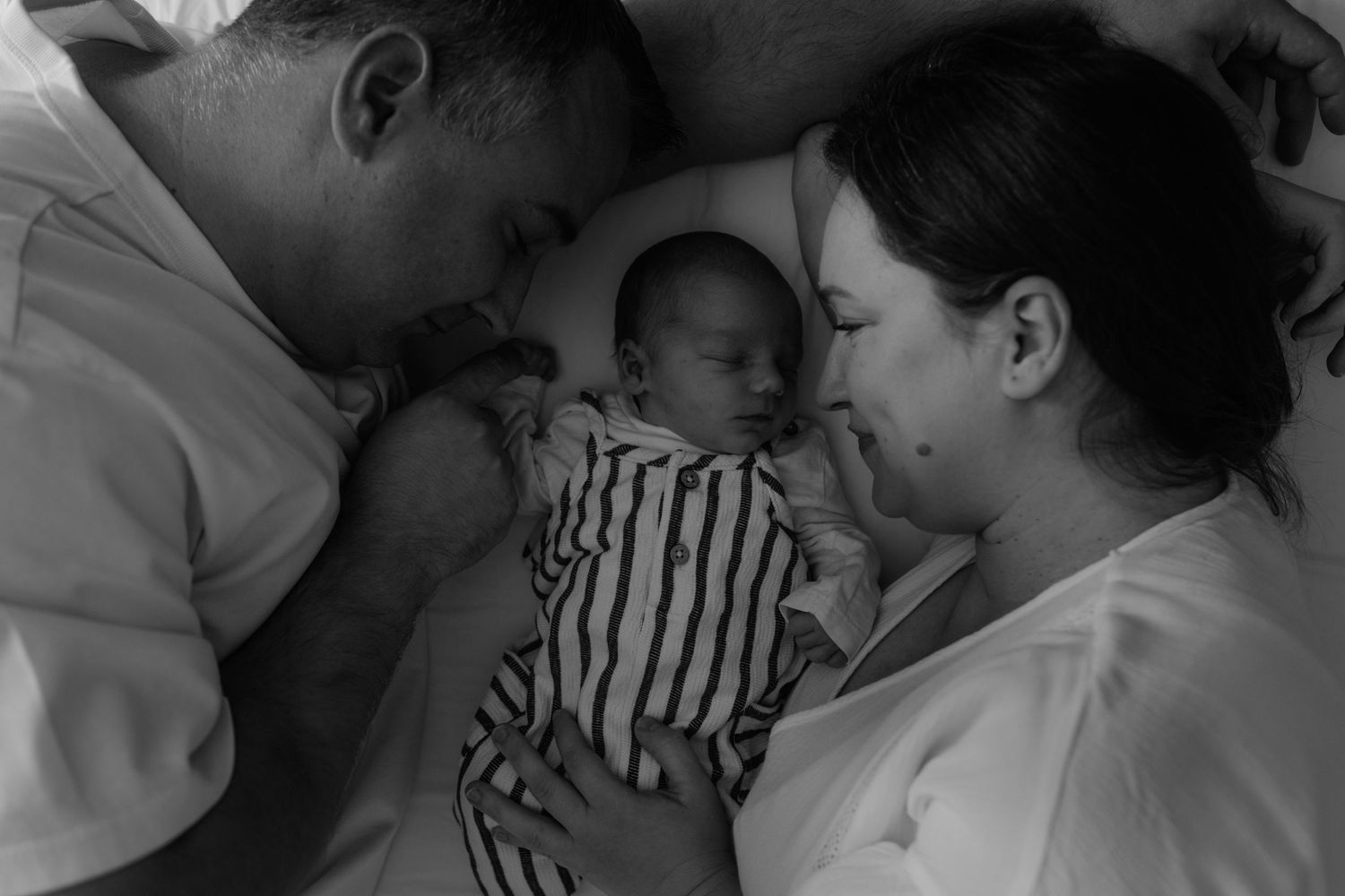 Tender family moment captured in intimate black and white photography.