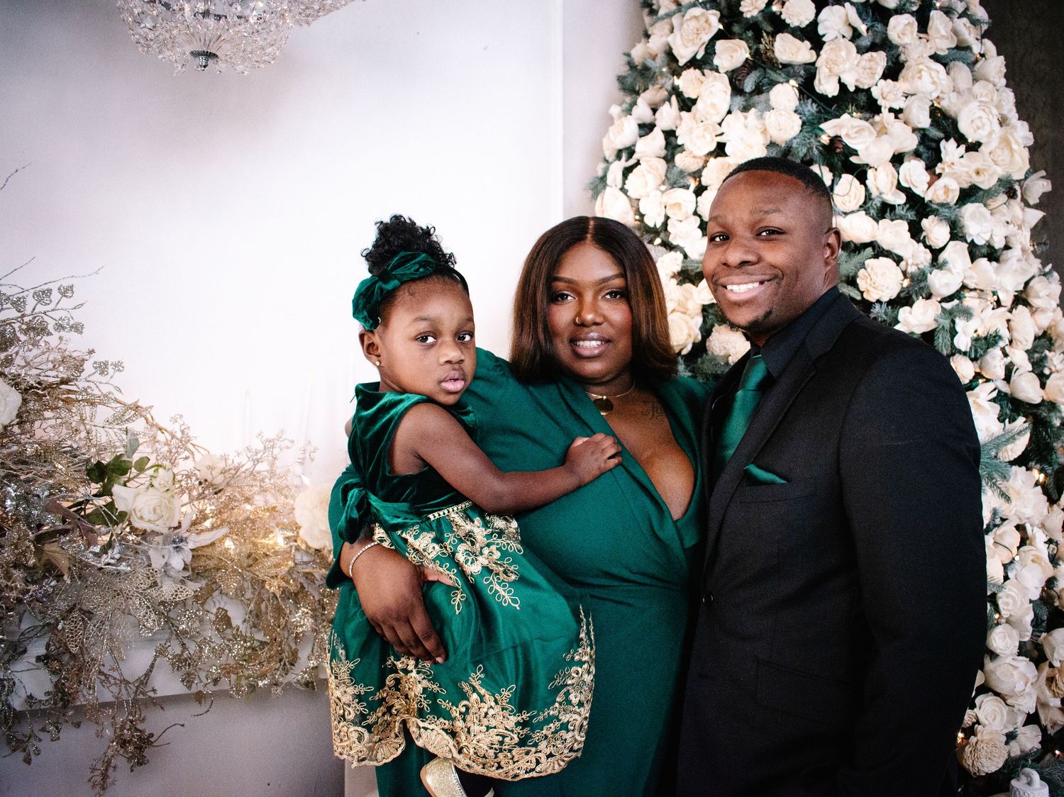 Family in emerald holiday outfits during elegant Christmas photo session in Tacoma.
