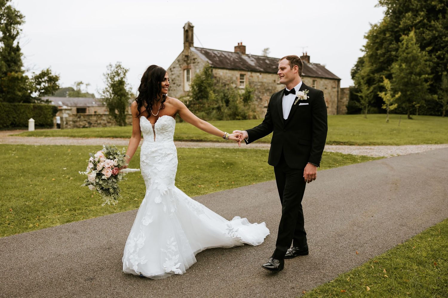 A series of candid moments captured on a paved pathway surrounded by green grass and trees on a sunny day.