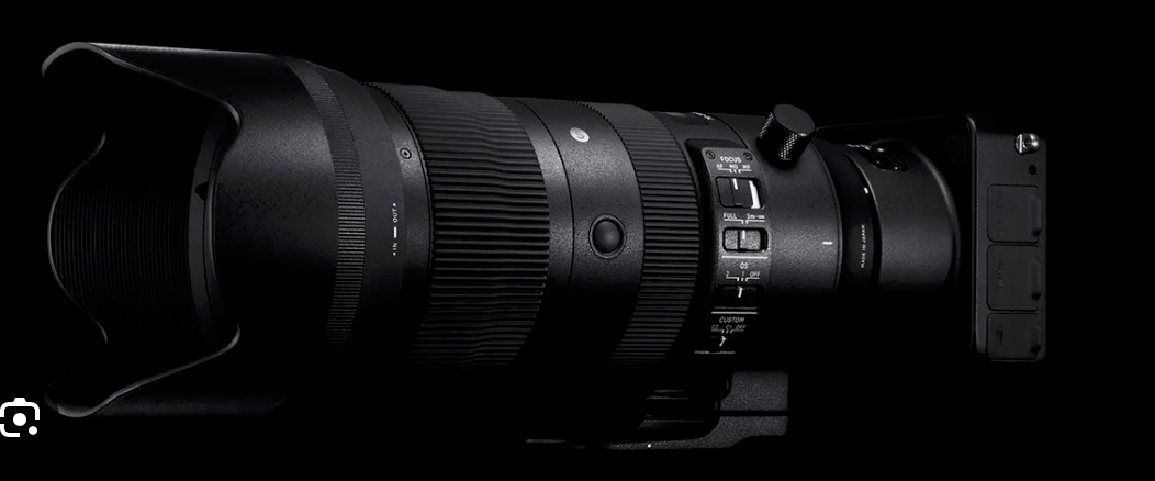 Professional camera lenses arranged in a row against black background.