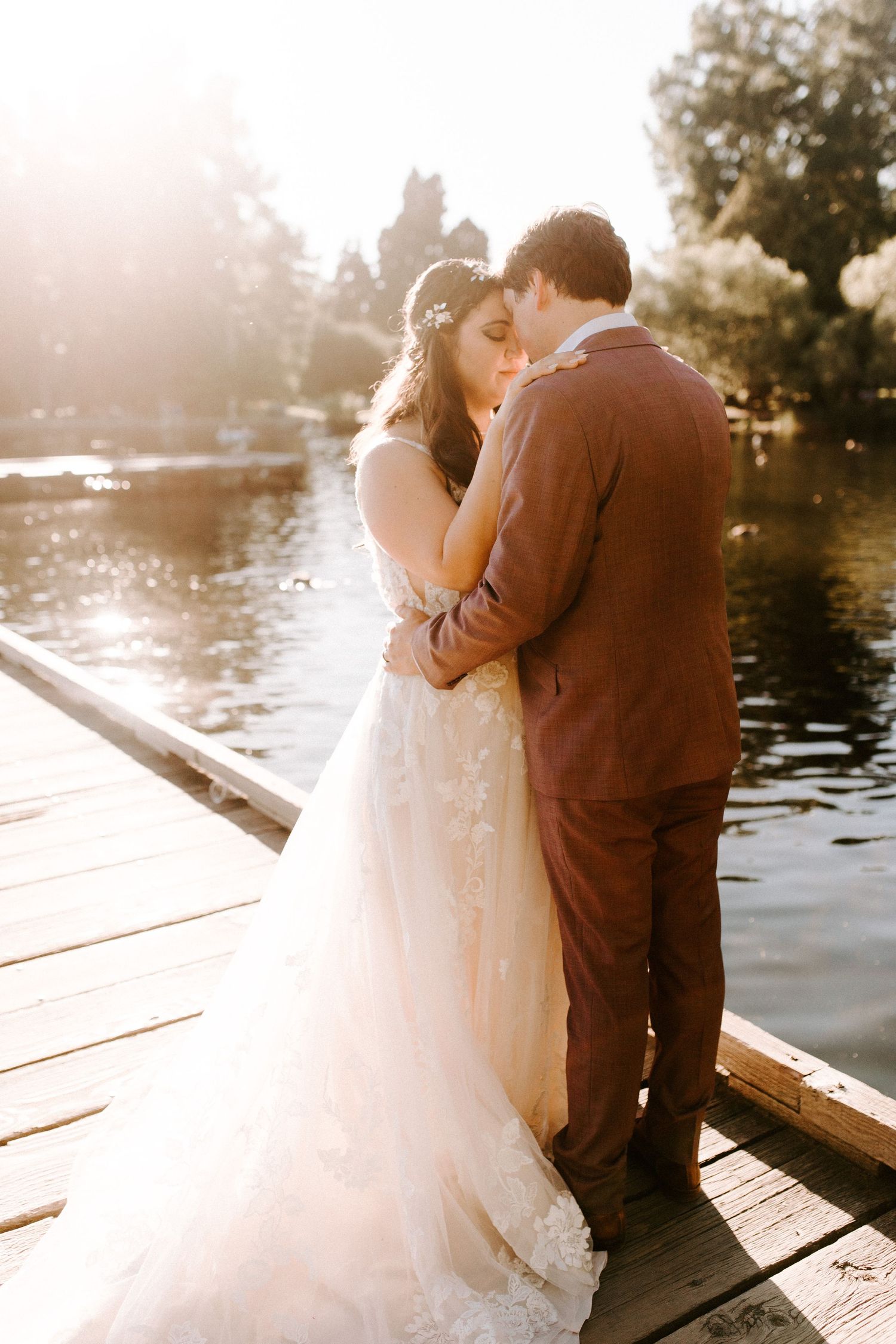 A romantic sunset moment captured on a dock overlooking a serene lake.