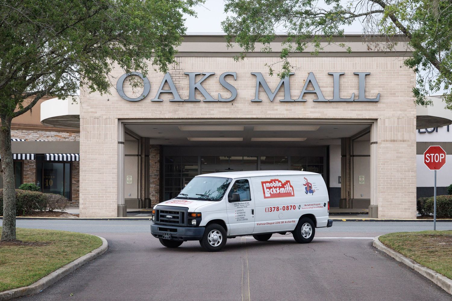 commercial photograph of a white mobile locksmith van parked in front of the Oaks Mall in Gainesville, Fl.