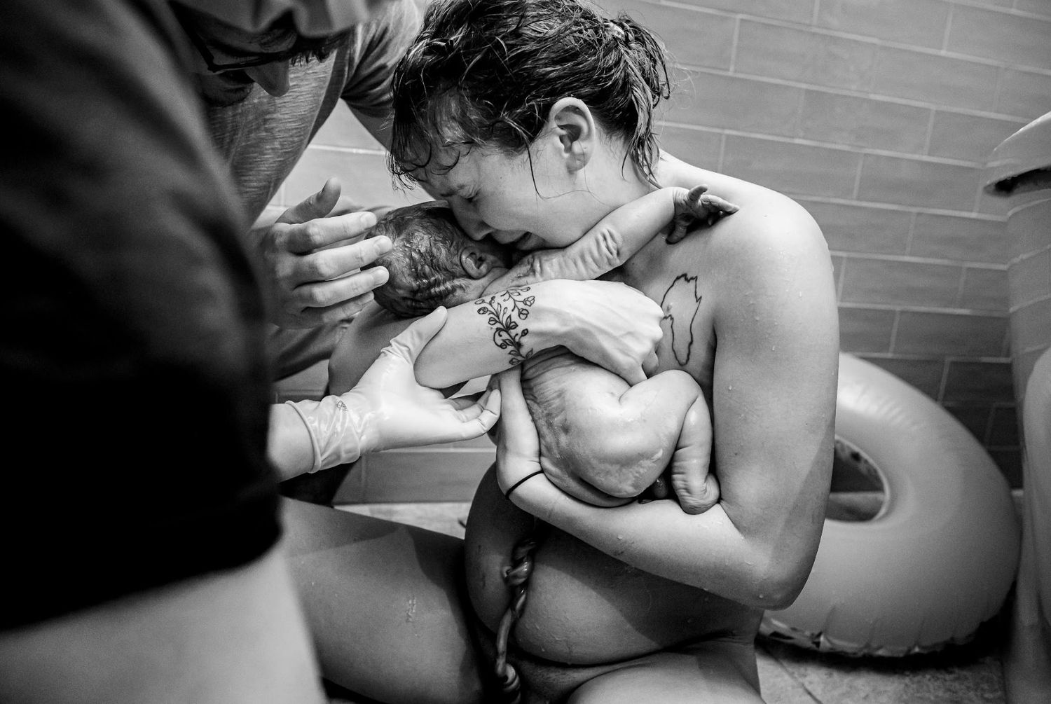 A mom holds her baby close immediately after he's born with the cord still attached