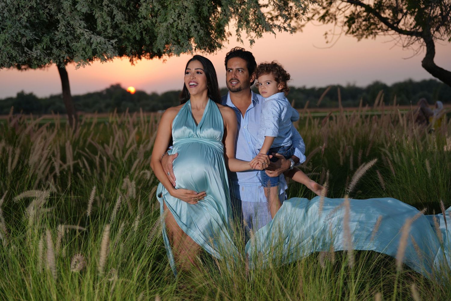 Family photography Dubai desert photoshoot with coordinated neutral outfits and soft golden hour lighting