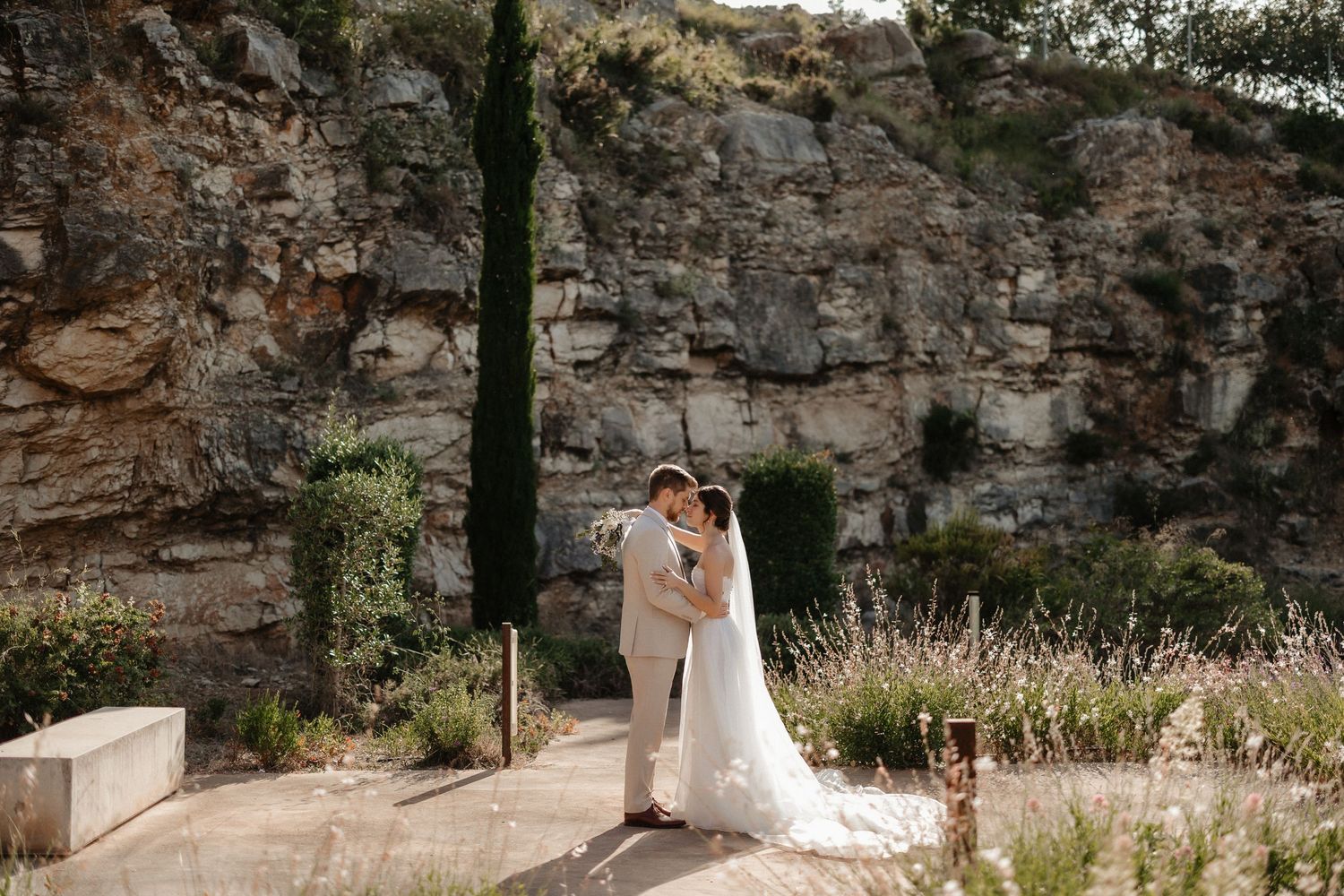 Romantic moment in a vineyard with mountains in background.