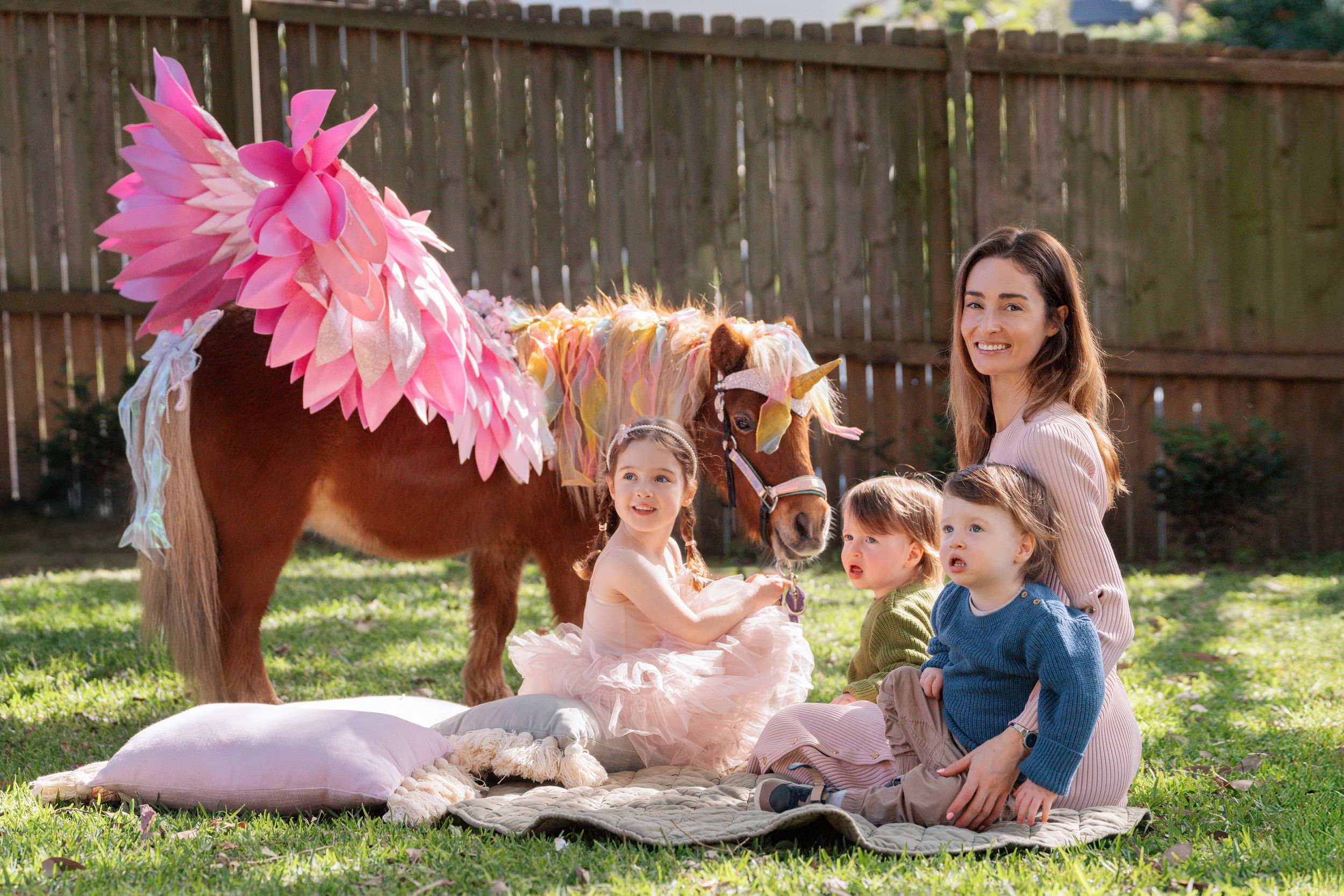 mom and her twins and her four year old daughter with a unicorn on her birthday photoshoot